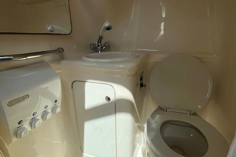 2003 Sea Ray 260 Sundancer boat bathroom with sink and toilet.