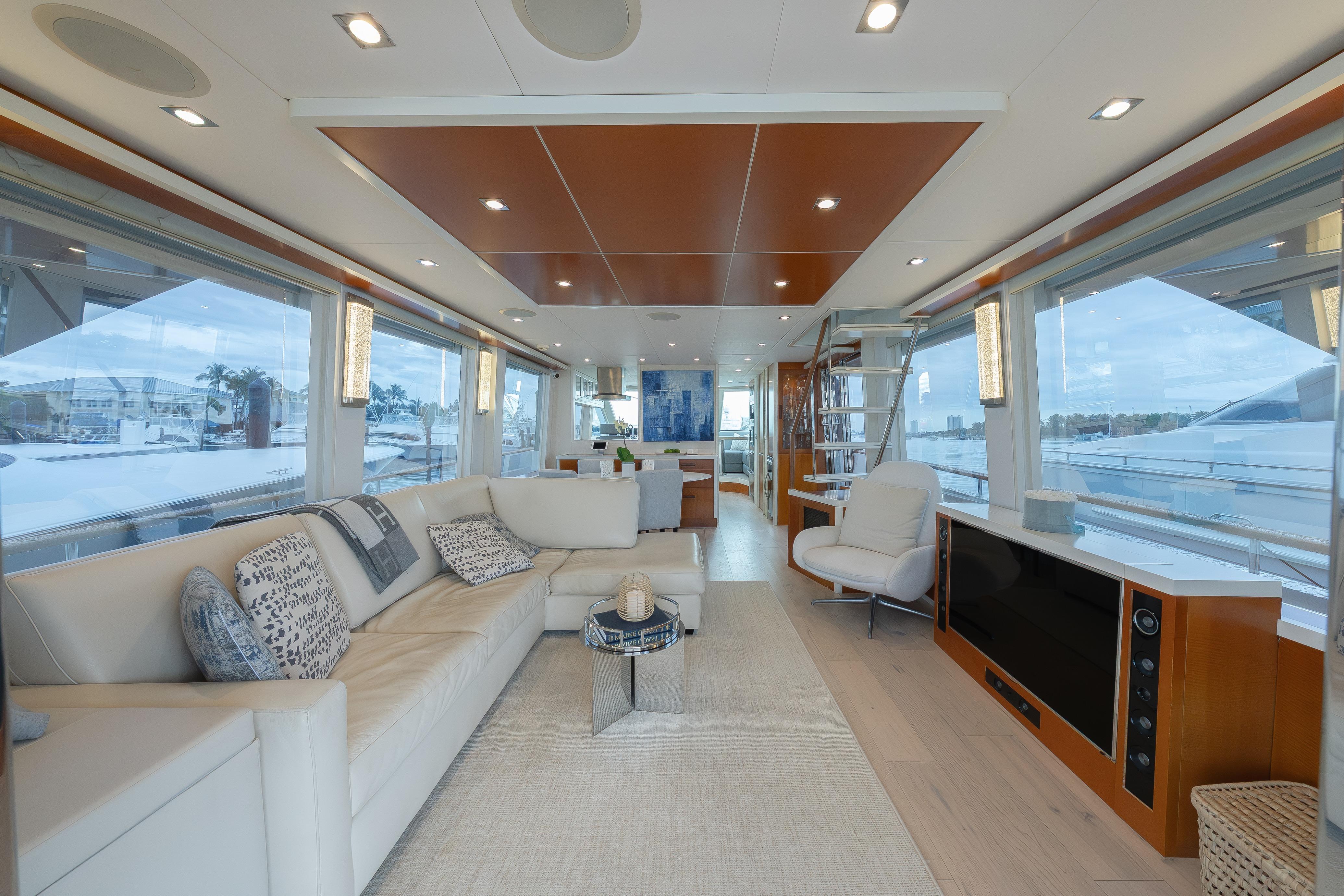 Luxurious interior of 2012 Lazzara Breeze yacht with modern furnishings and panoramic windows.