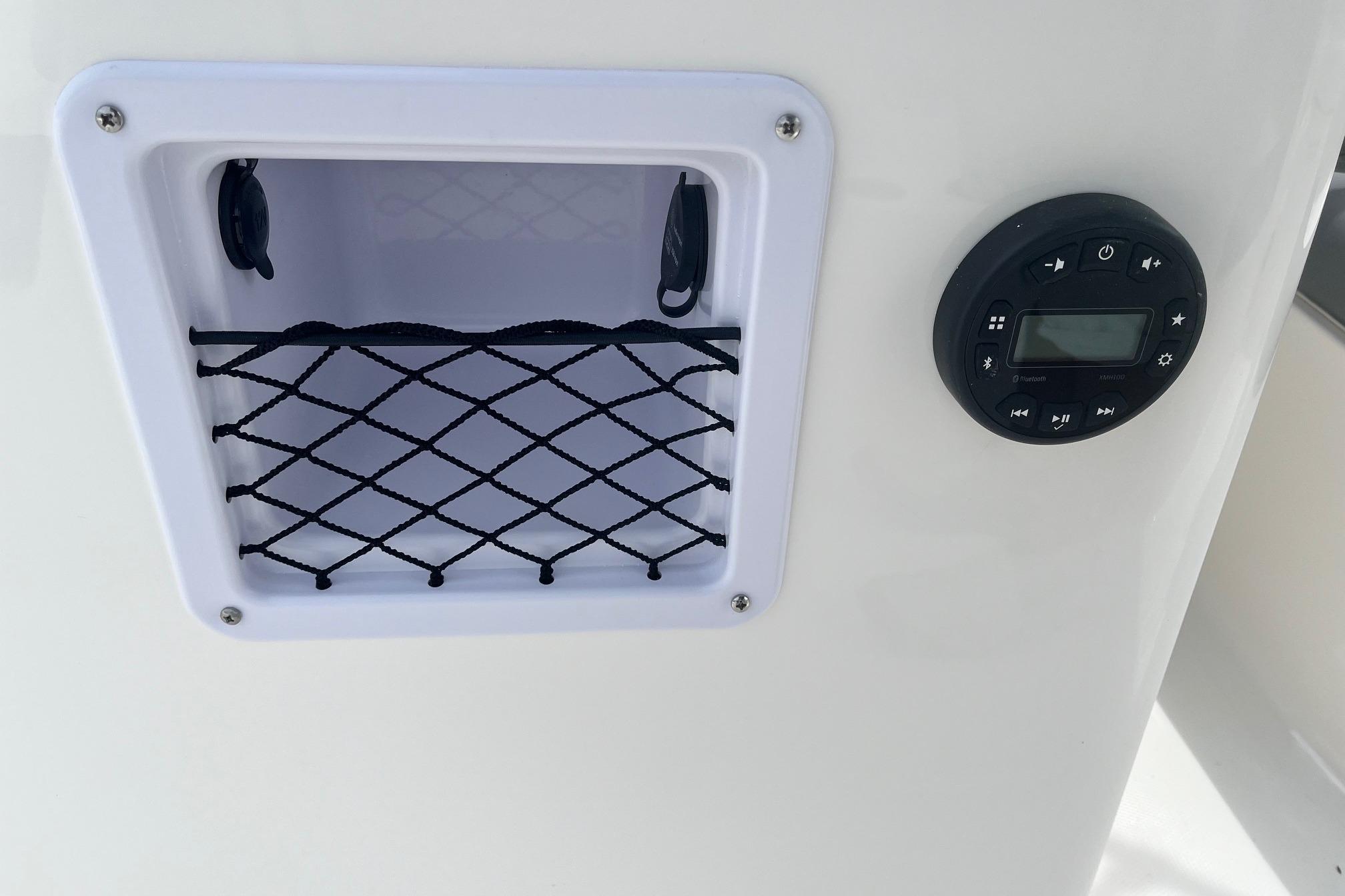 2026 Bayliner Element E16 boat storage compartment and control panel.