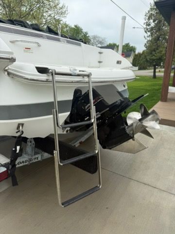 A 2001 Cobalt 226 with a swim ladder and propeller at the stern.