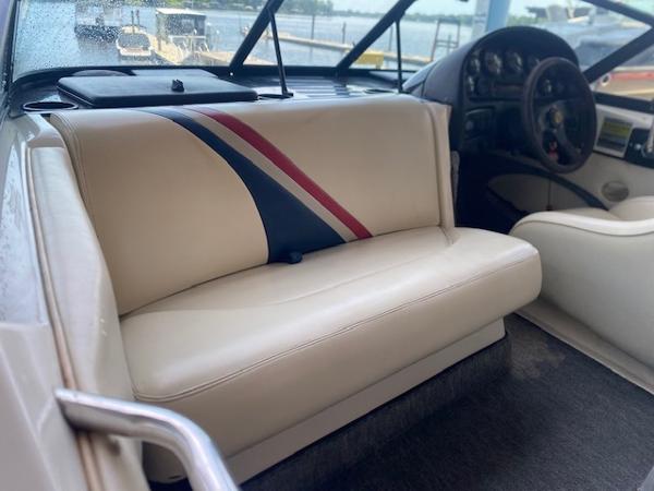 1998 Malibu Response boat interior with beige seating and striped design.