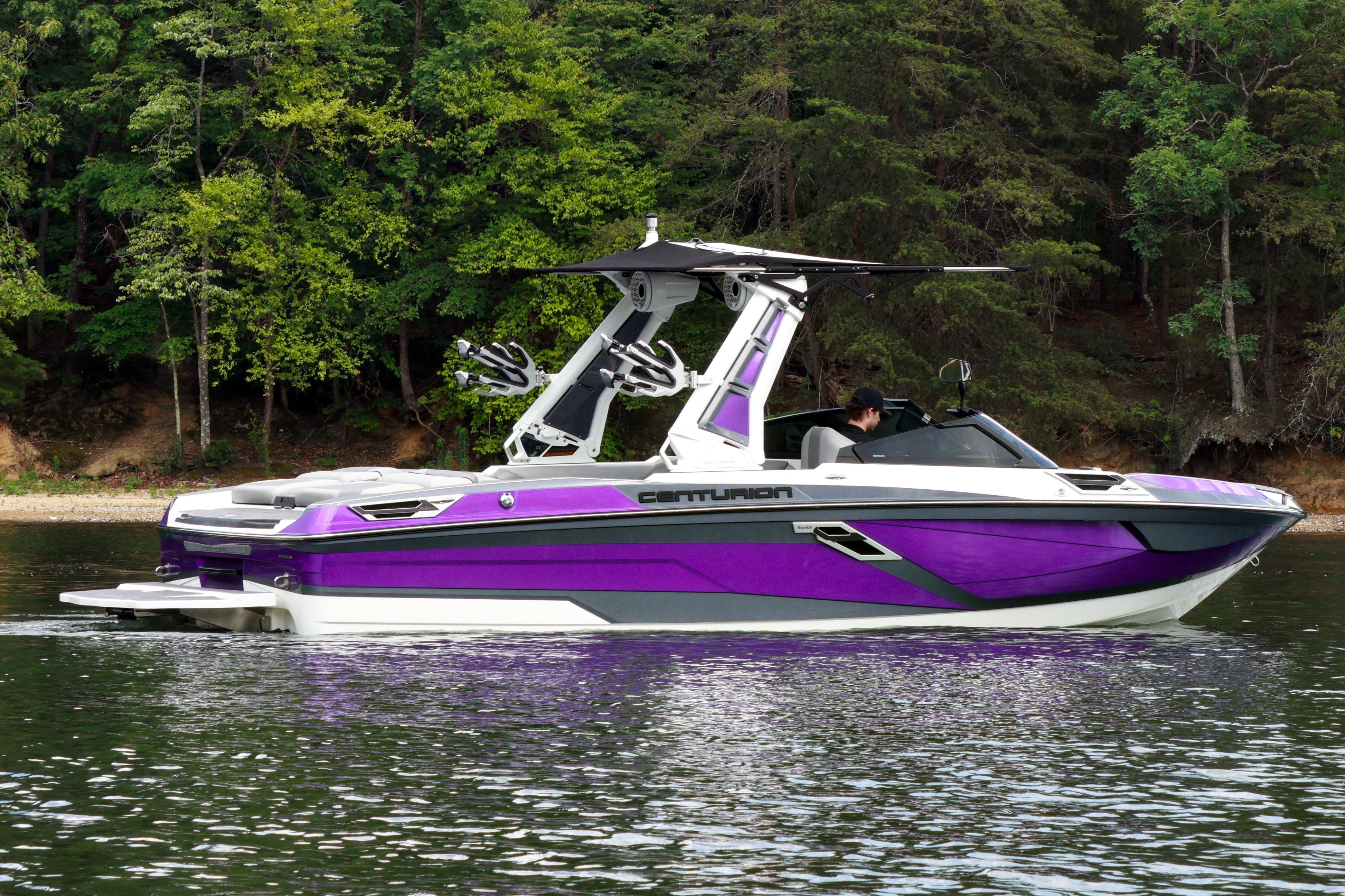 2022 Centurion Ri245 boat in vibrant purple on a serene lake.