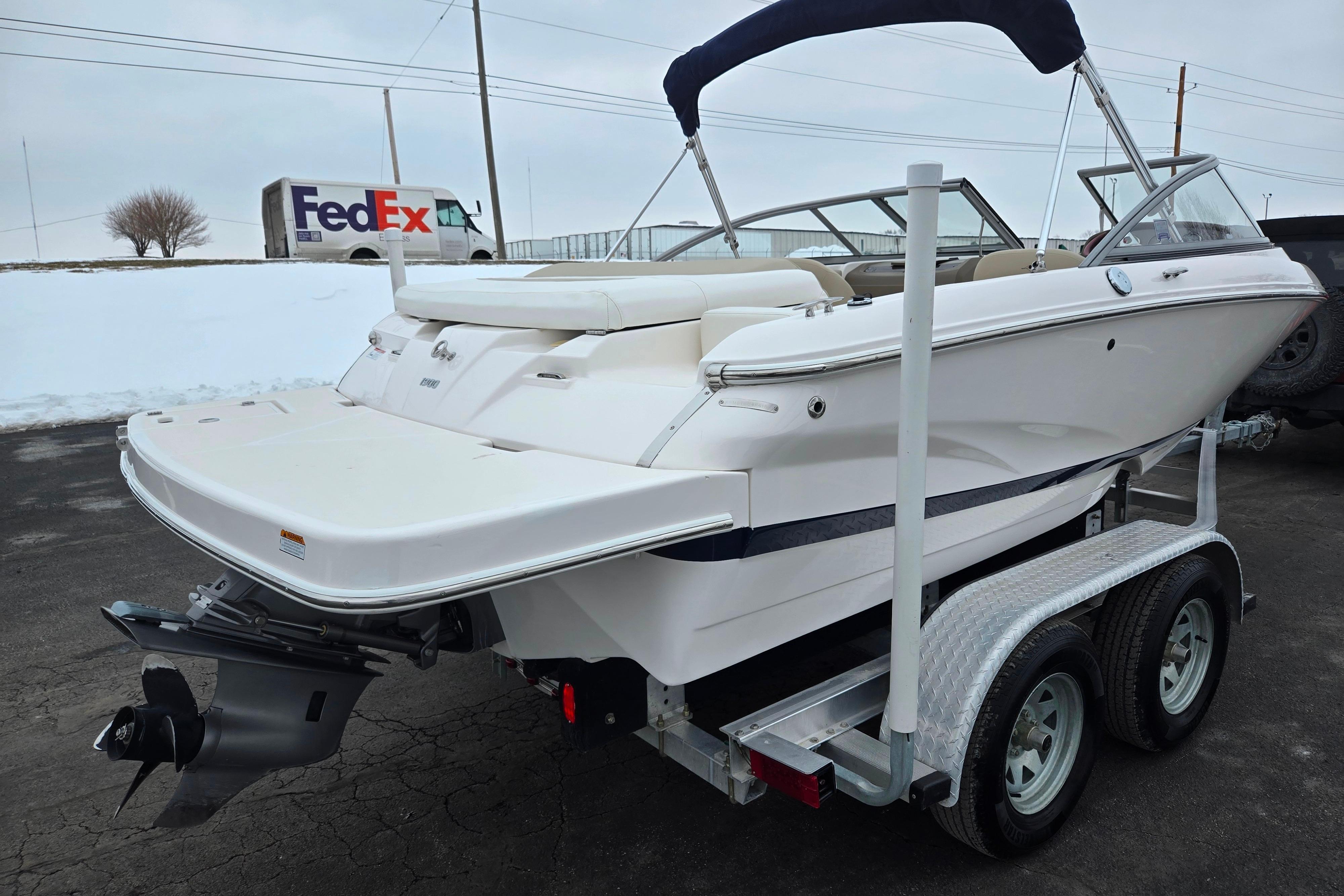 2015 Regal 1900 ES Bowrider on trailer, parked outdoors with FedEx truck in background.