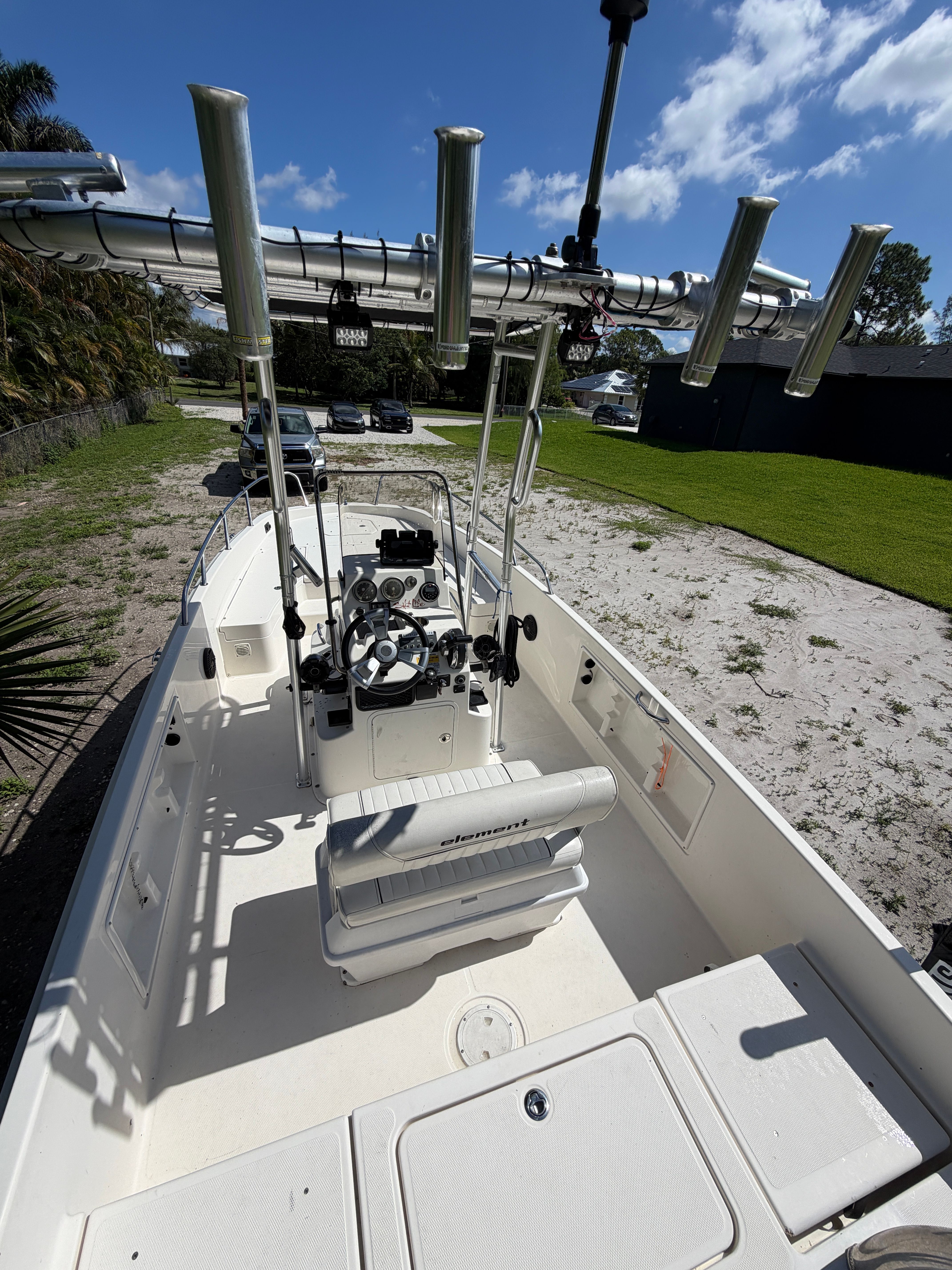 2018 Bayliner Element F21 boat with helm console and fishing rod holders.