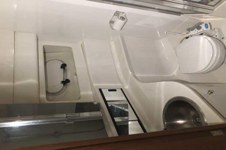 Bathroom interior of 1997 Bayliner 3988 Motoryacht with toilet and sink.