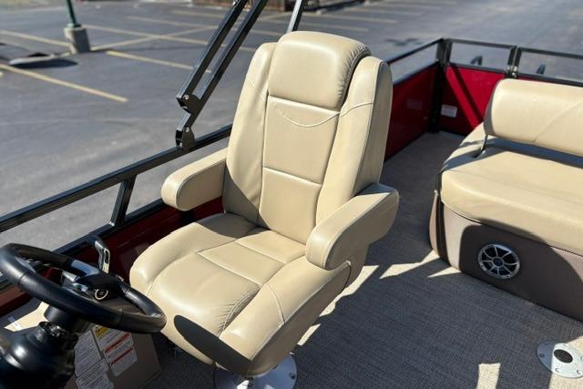 Captain's chair on 2025 Regency 250 DL3 pontoon boat, beige upholstery, steering wheel visible.