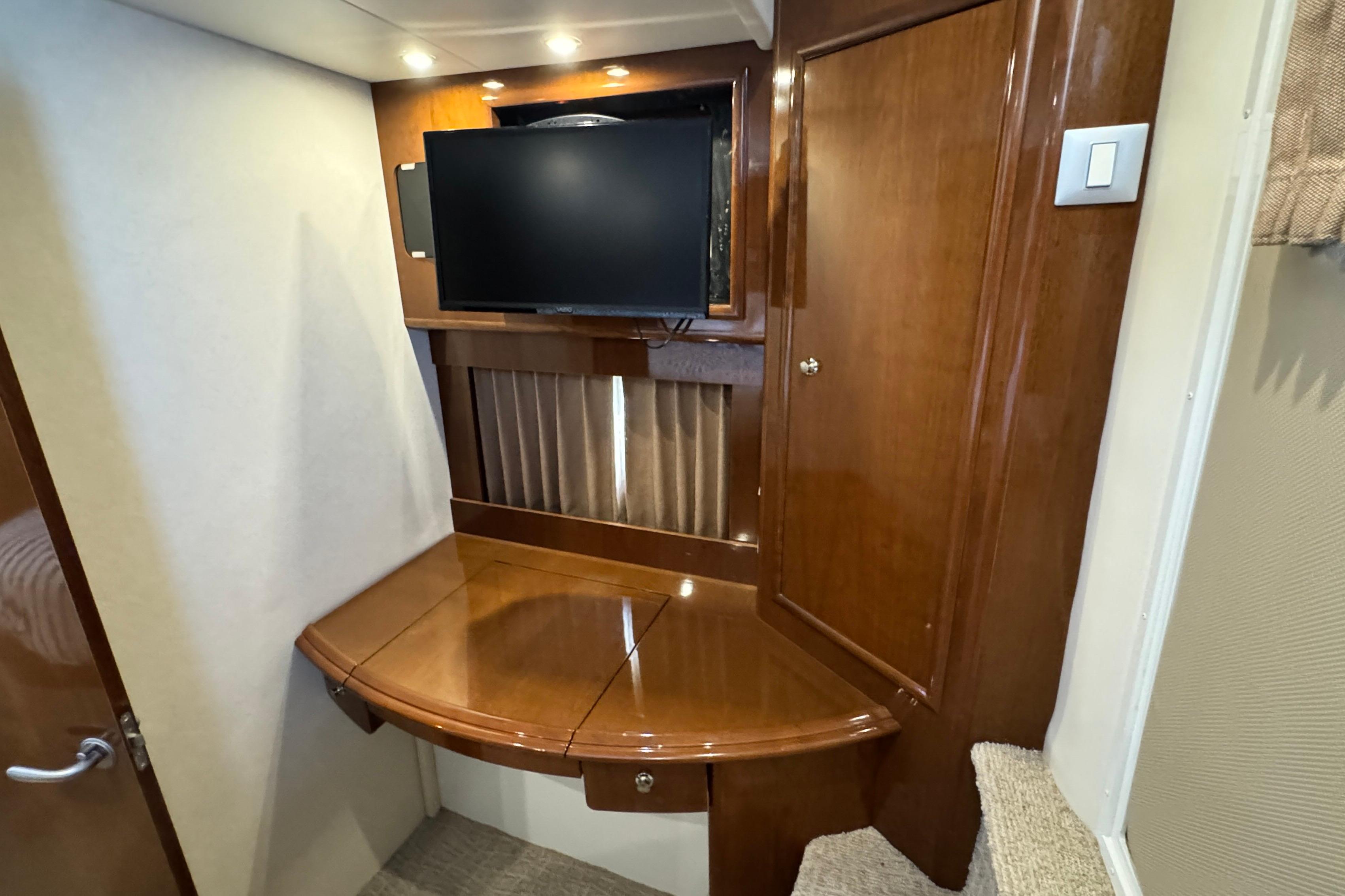 2007 Carver 47 Motor Yacht Owner's Aft Stateroom with TV, wooden cabinetry, and ambient lighting