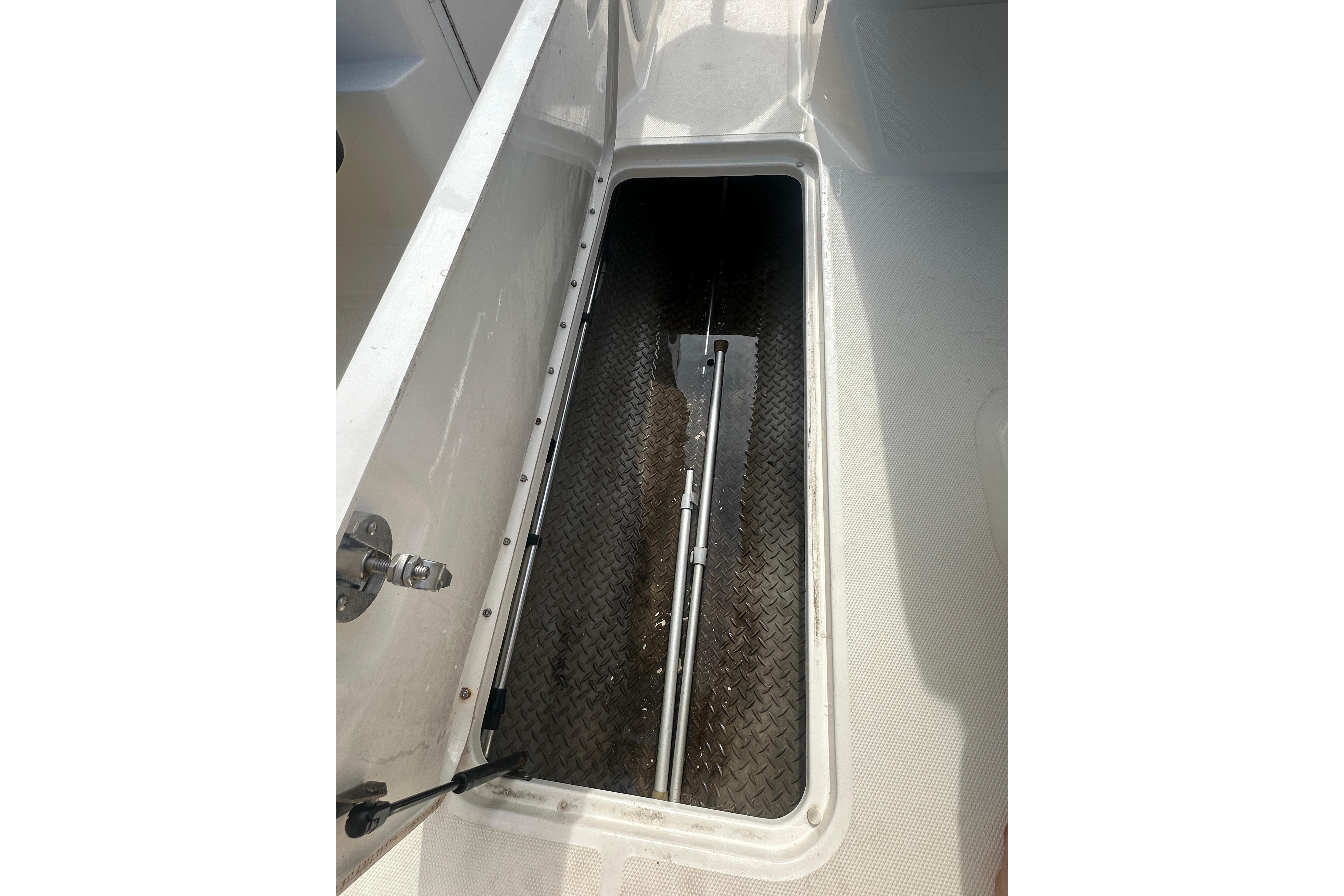 Storage compartment of 2017 Sea Ray SPX 190 Outboard boat, featuring diamond-patterned flooring.