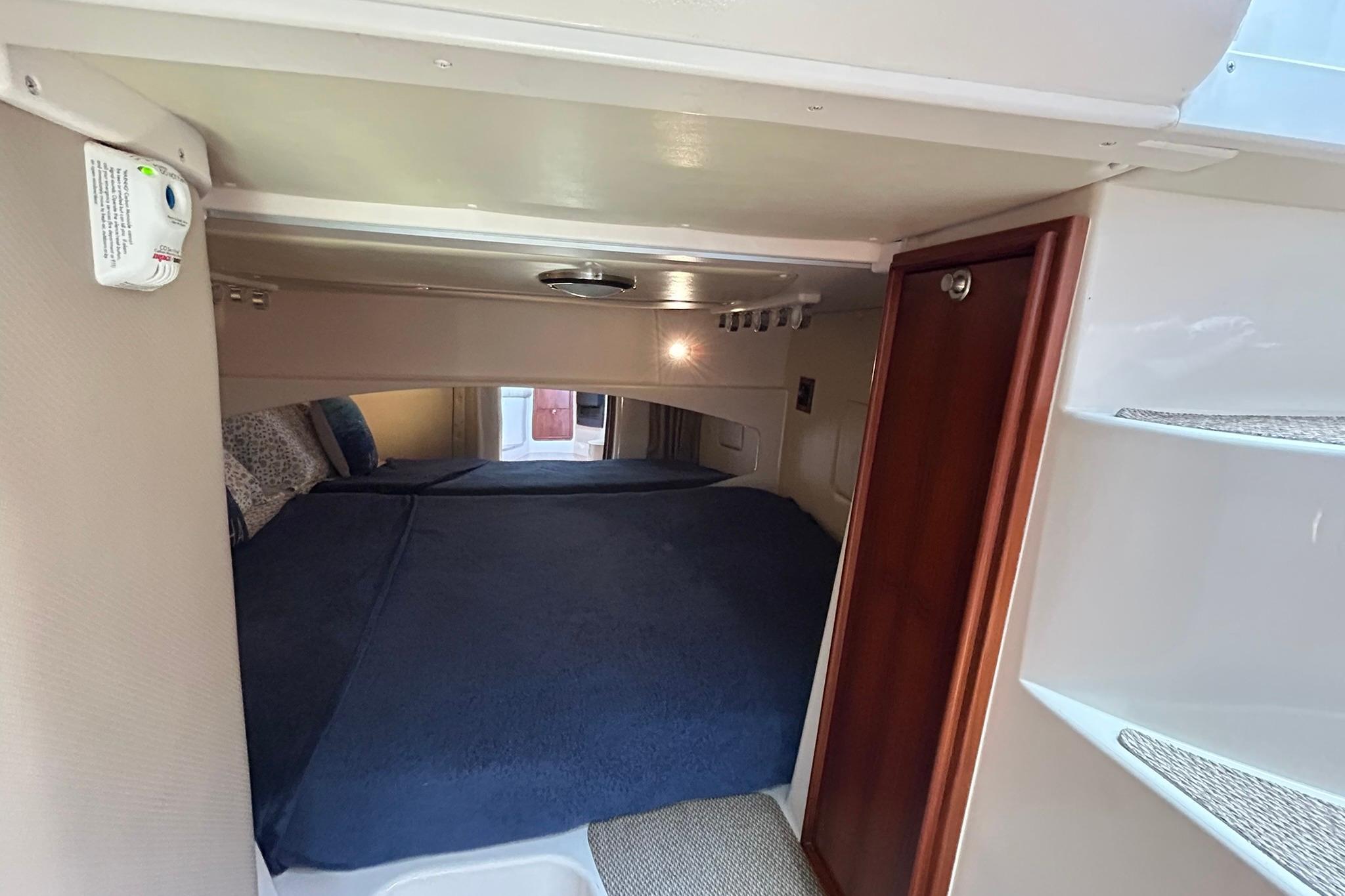 2007 Grady-White Express 360 cabin interior with cozy bed and wooden accents.