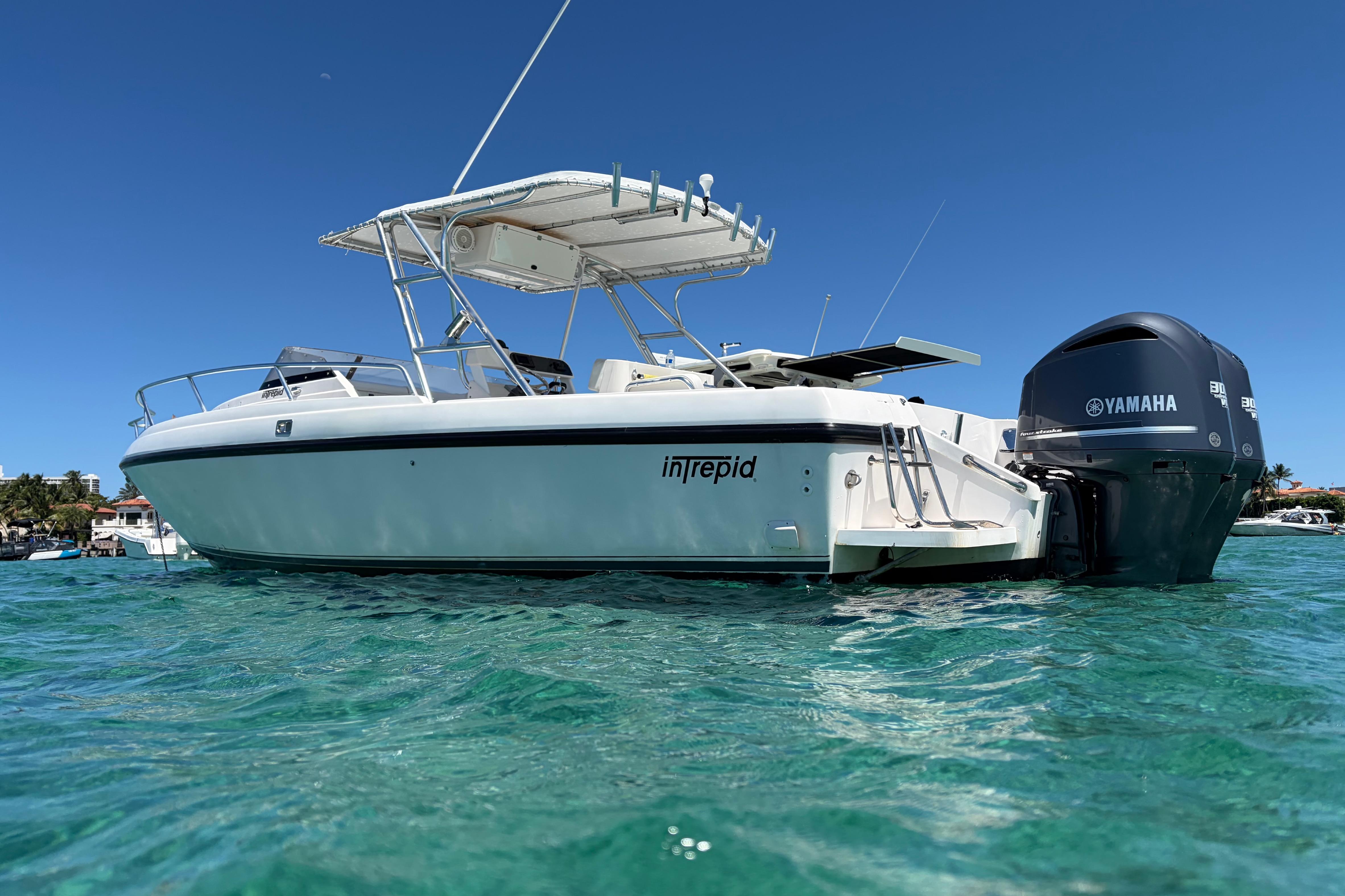 1998 Intrepid 339 Walkaround boat with Yamaha engines on clear blue water.