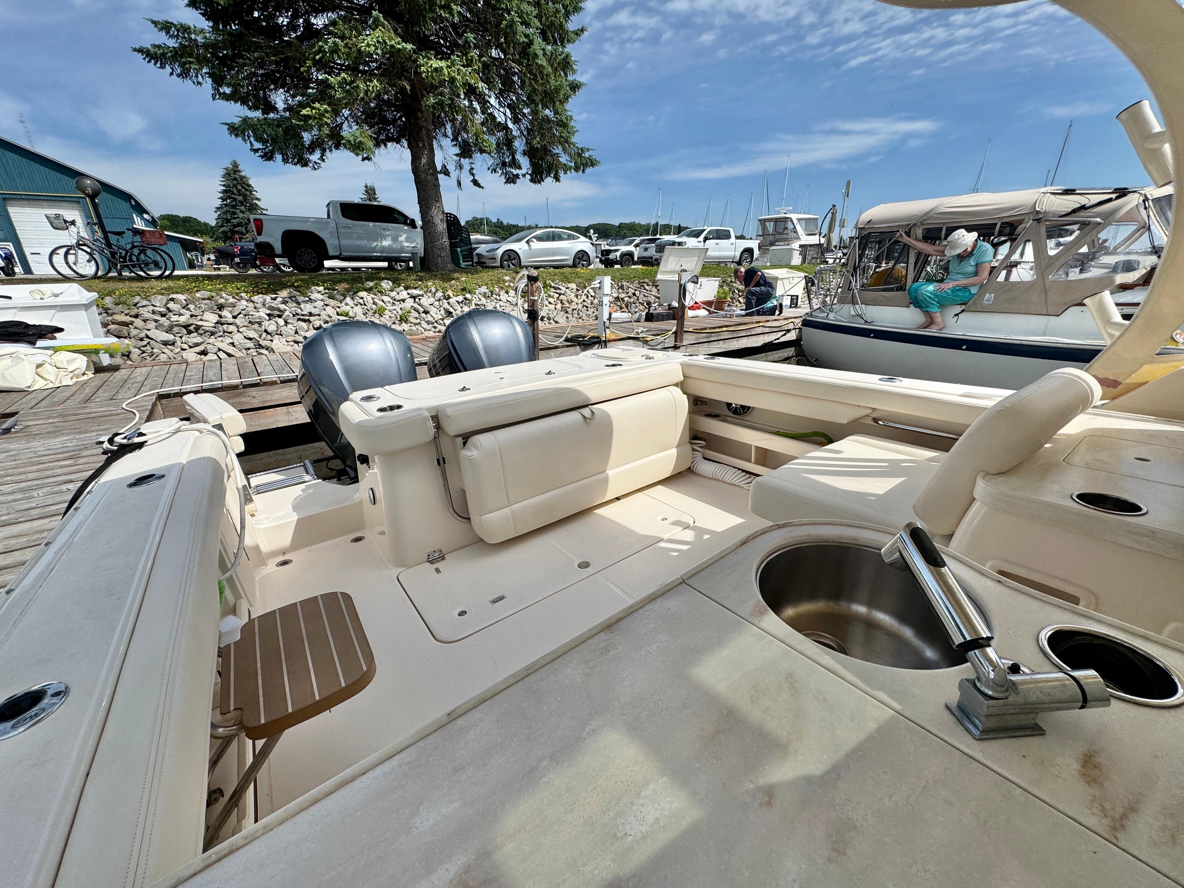2019 Grady-White Freedom 307 boat docked, featuring dual engines and spacious seating.