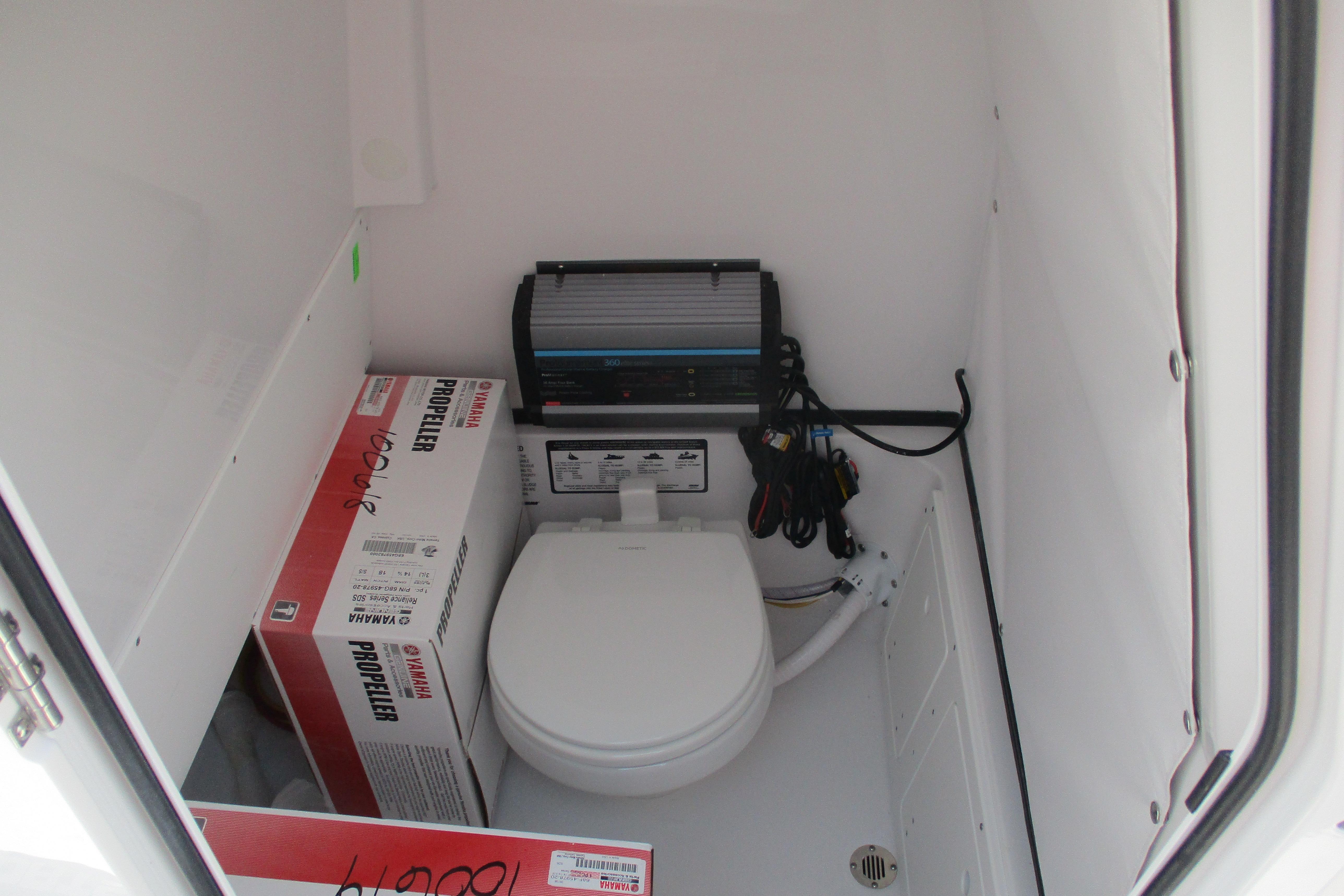 Interior of 2027 Sportsman Open 252 Center Console boat with toilet and Yamaha propeller box.
