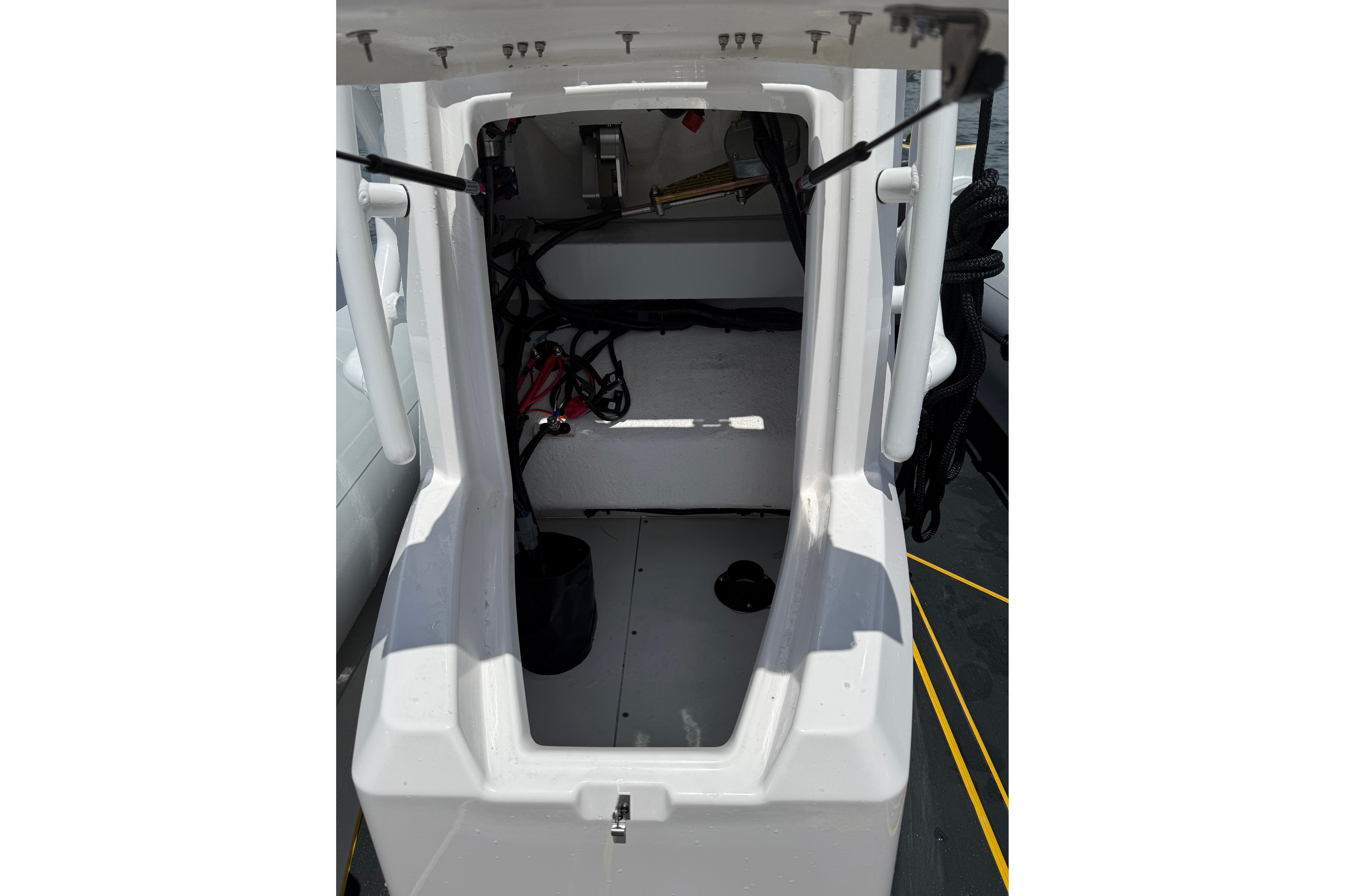 Interior view of 2026 Highfield Velox 560 boat, showcasing storage compartment and equipment.