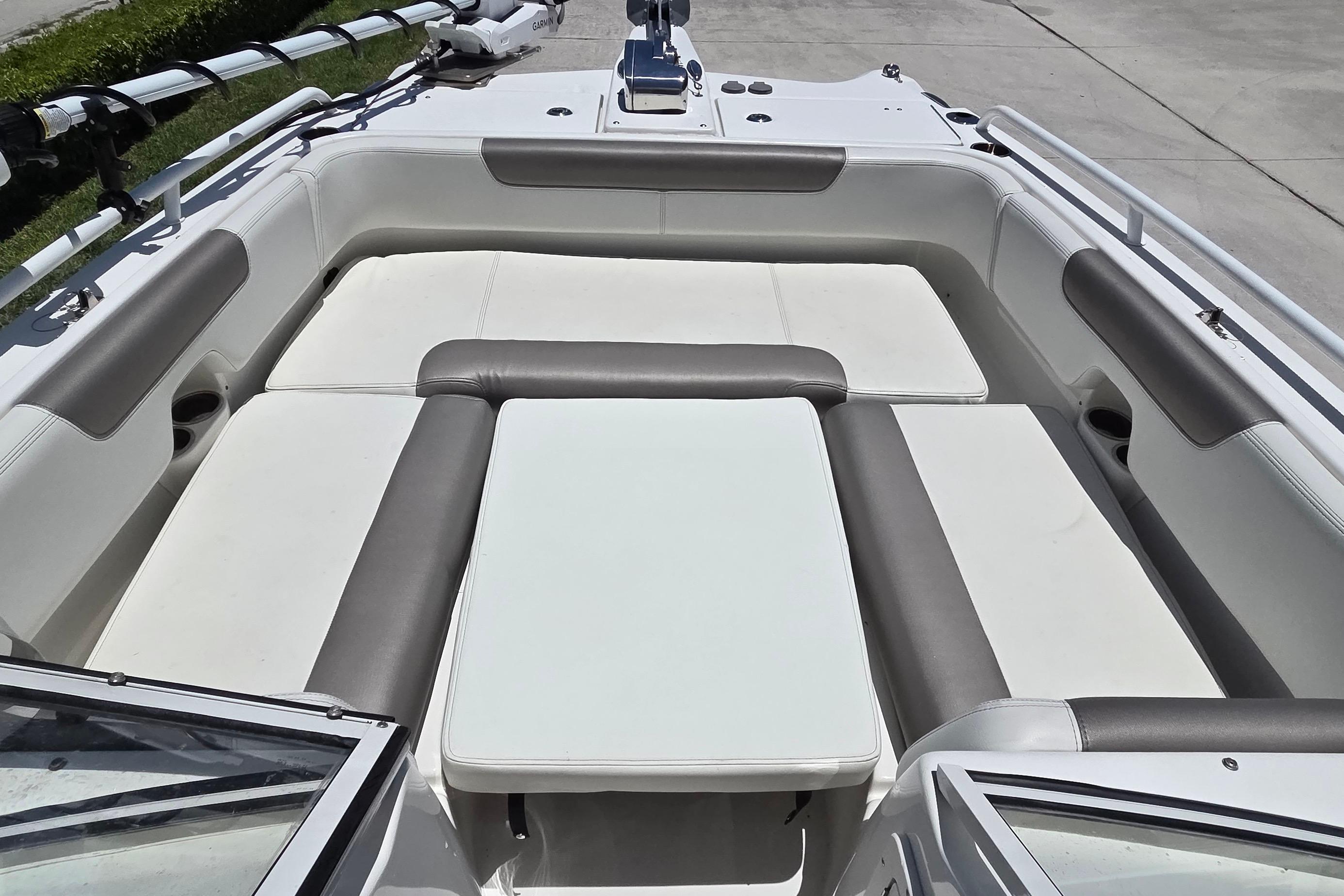 2022 World Cat 255 DC boat interior with cushioned seating and table.