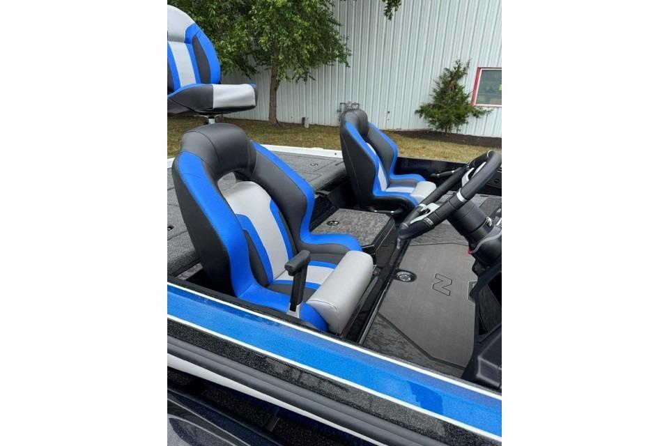 2026 Nitro Z21 XL boat interior with blue and gray seats, steering wheel visible.