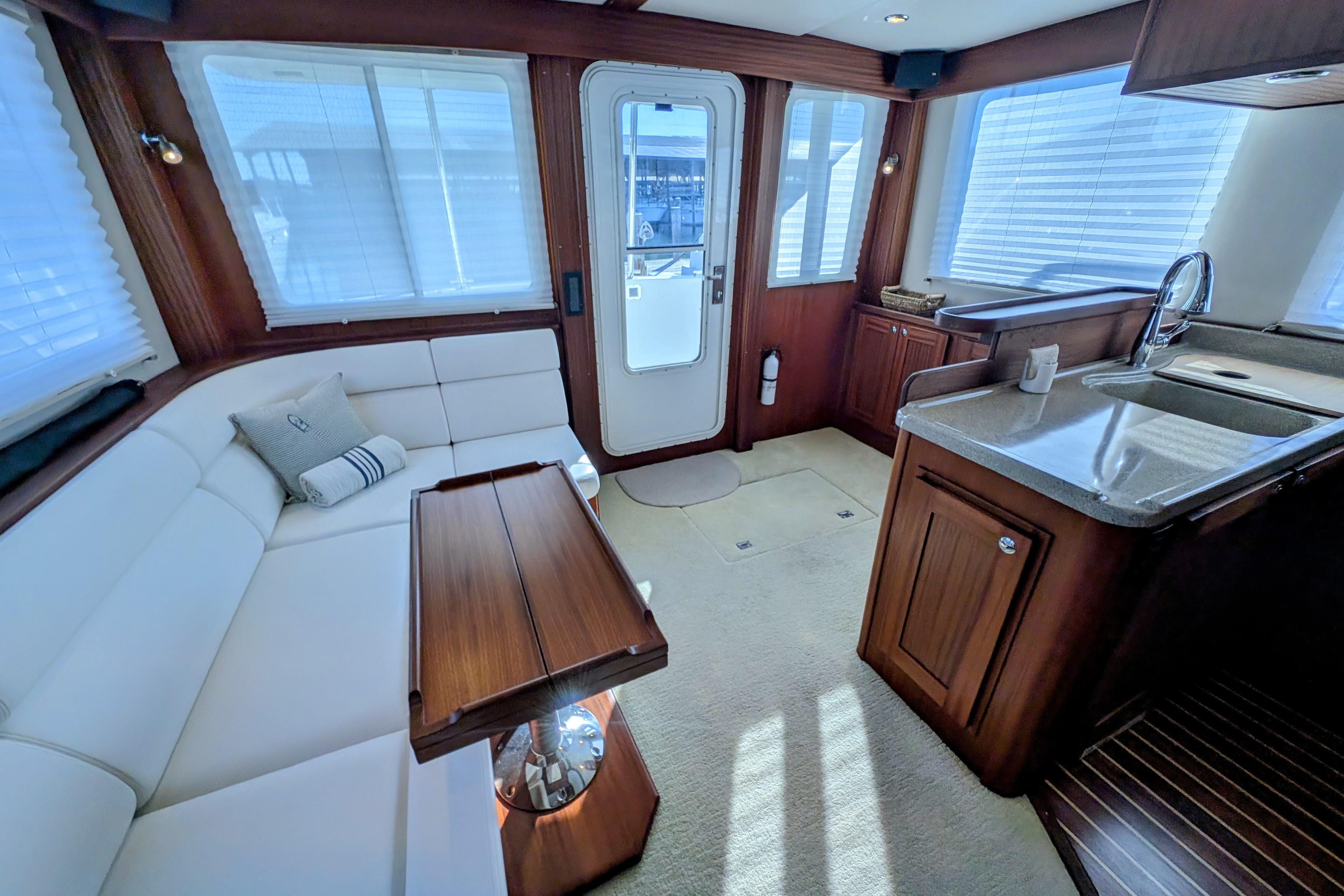 Luxurious interior of 2015 American Tug 435 with elegant seating and modern kitchen amenities.
