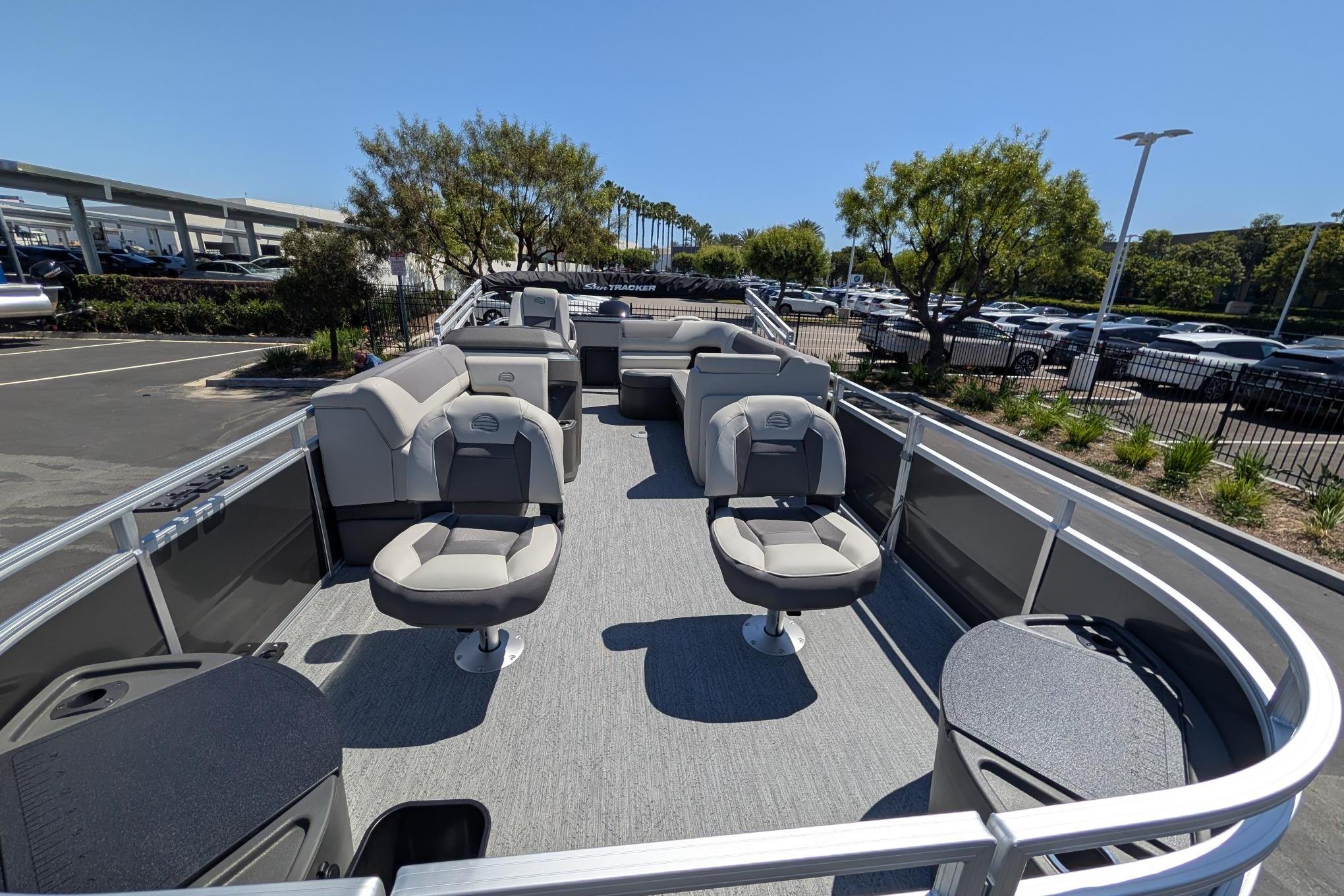 2026 Sun Tracker Fishin' Barge 22 DLX pontoon boat with spacious seating and modern design.