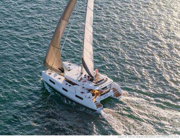 2025 Lagoon 46 ICONIC catamaran sailing on open water, aerial view.