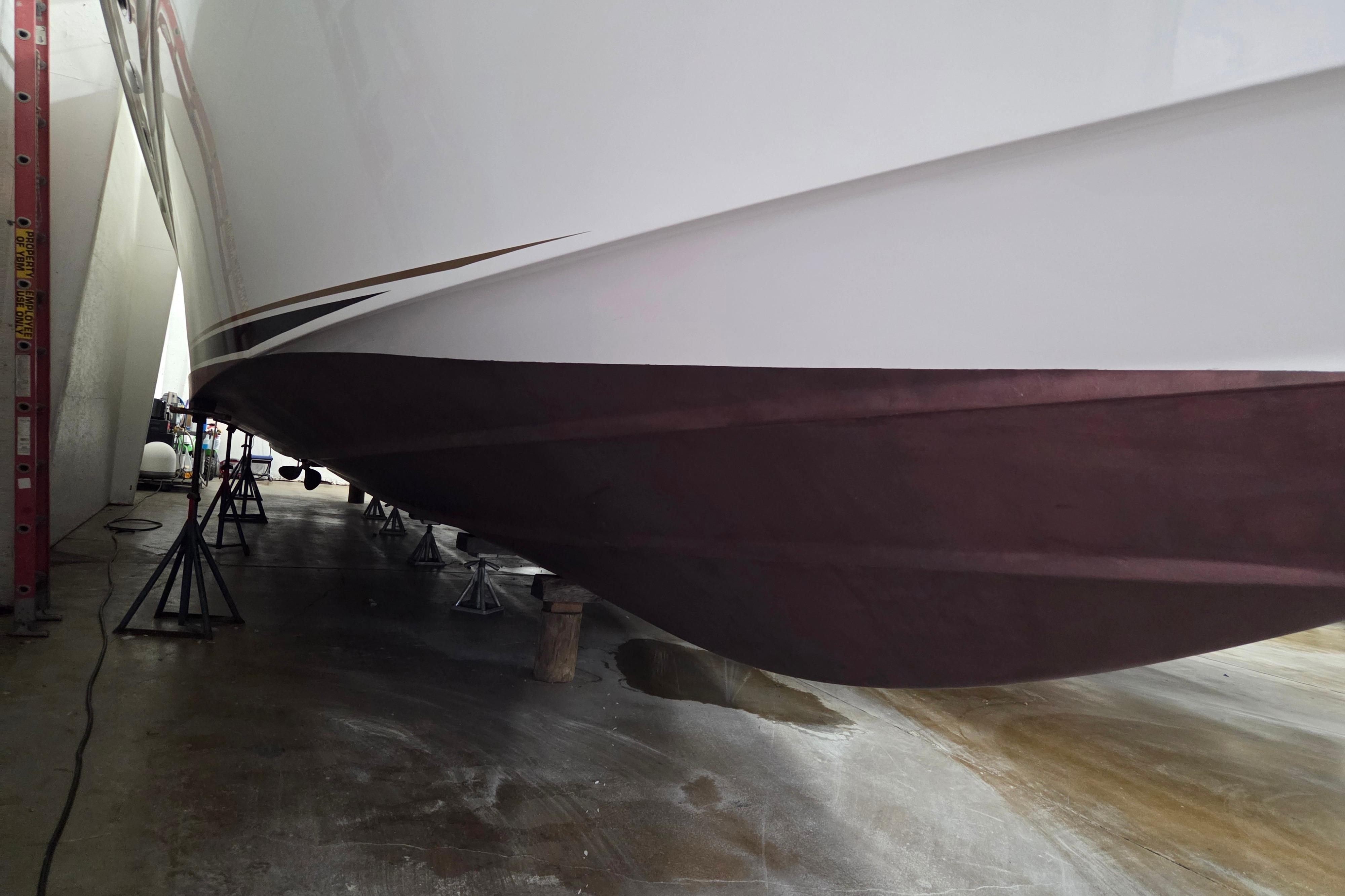 2000 Sea Ray Sundancer 540 yacht hull on stands in a maintenance facility.