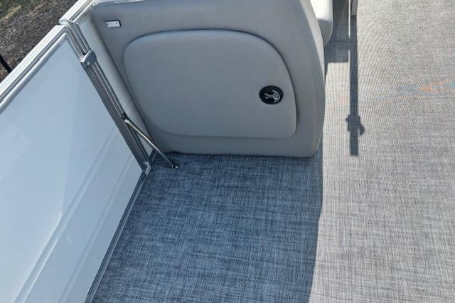 2026 Sun Tracker Party Barge 18 DLX interior with gray flooring and seating.