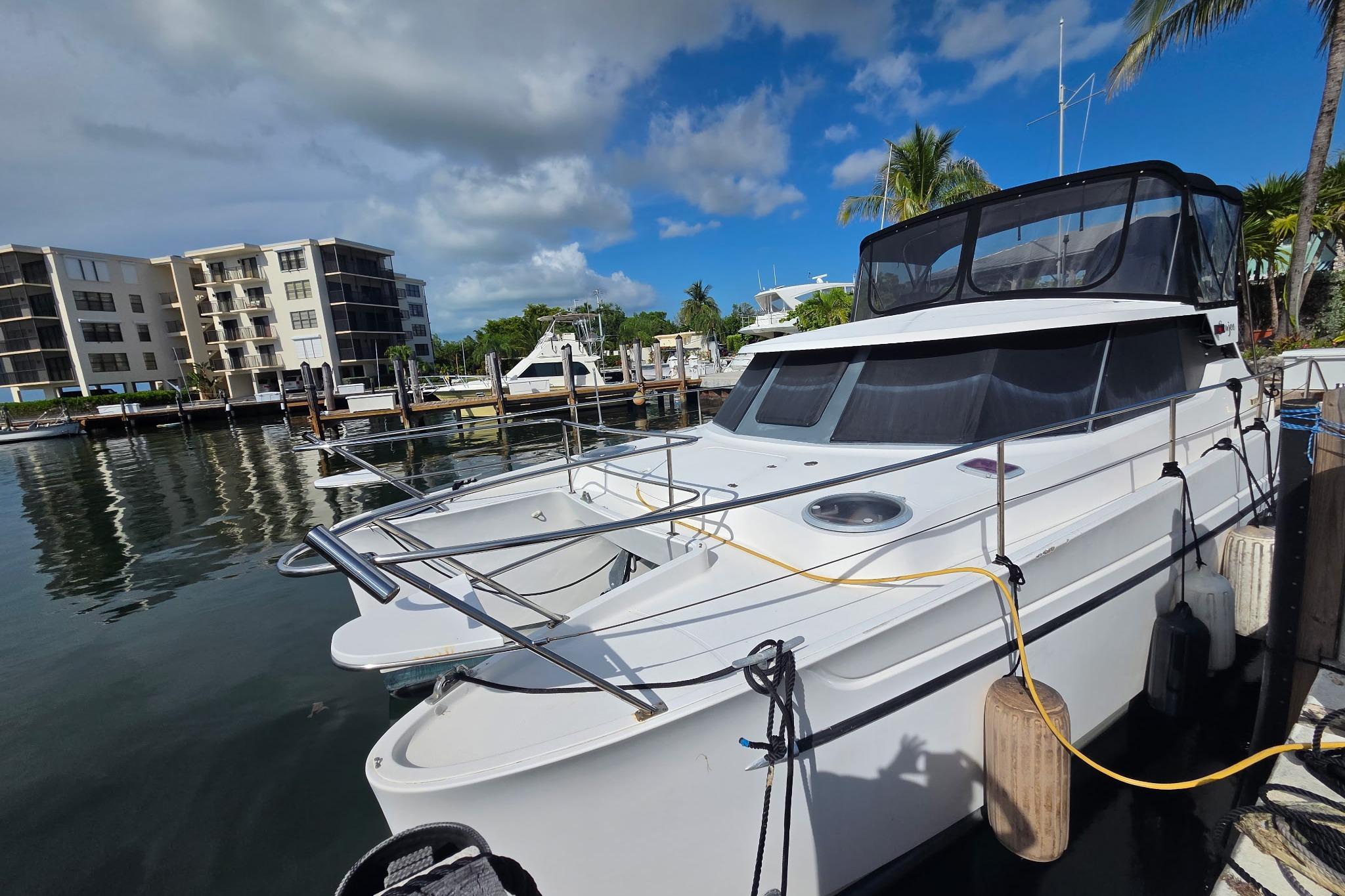 Fountaine Pajot Maryland 37 yacht docked at marina, 2000 model, under clear blue sky.