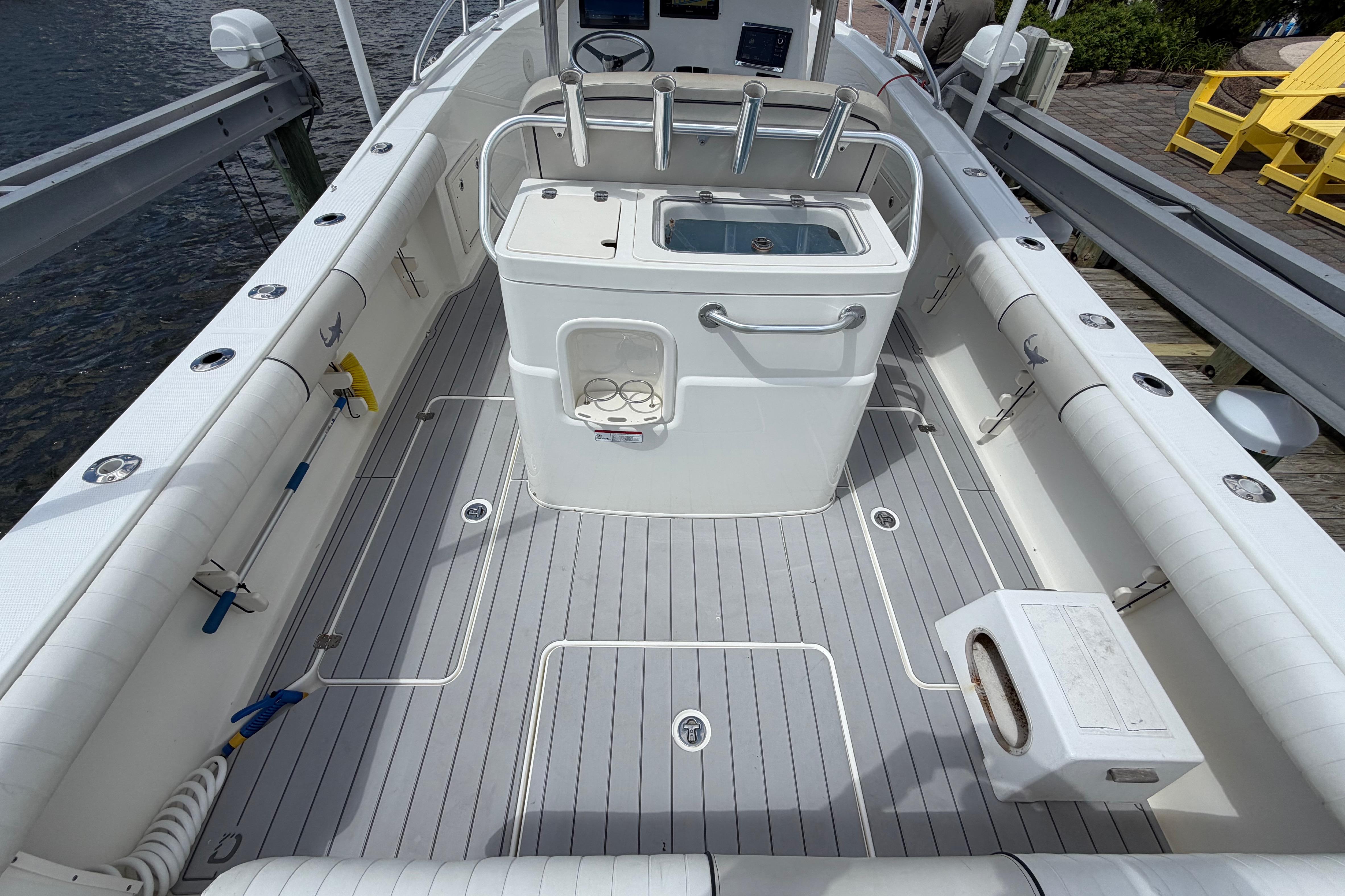 2017 Mako 284 Center Console boat interior with fishing rod holders and storage compartments.