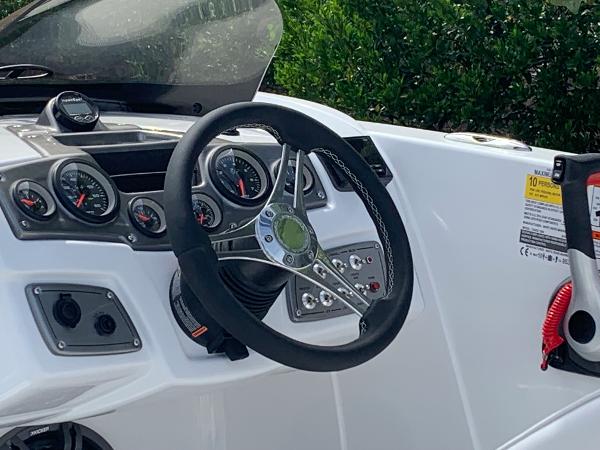 2024 Tahoe 1950 boat dashboard with steering wheel and gauges.