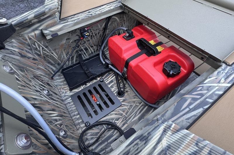 2026 Tracker Grizzly 1756 T Marsh boat interior with red fuel tank and camo design.