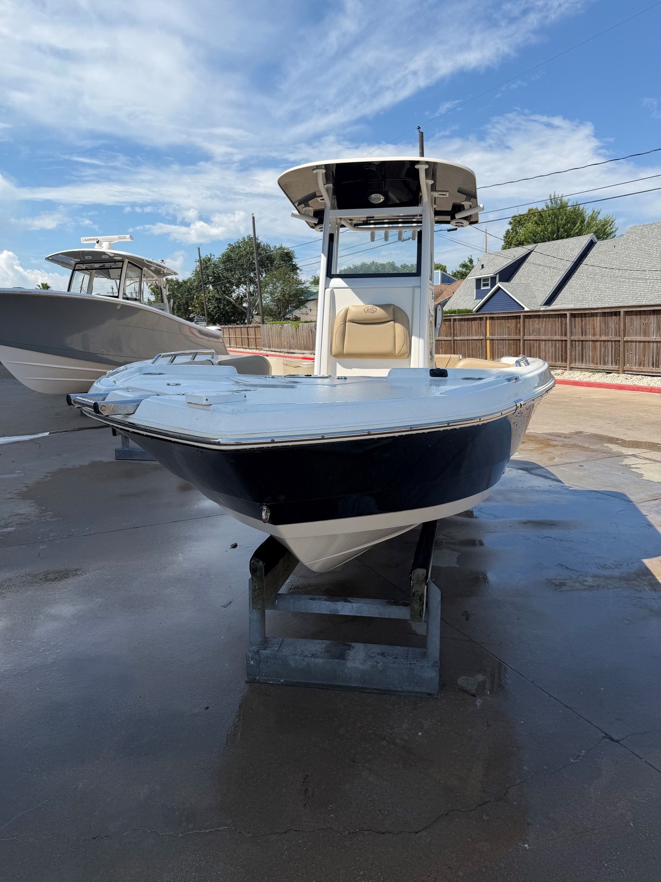 2019 NauticStar 251 Hybrid boat on a parking lot.