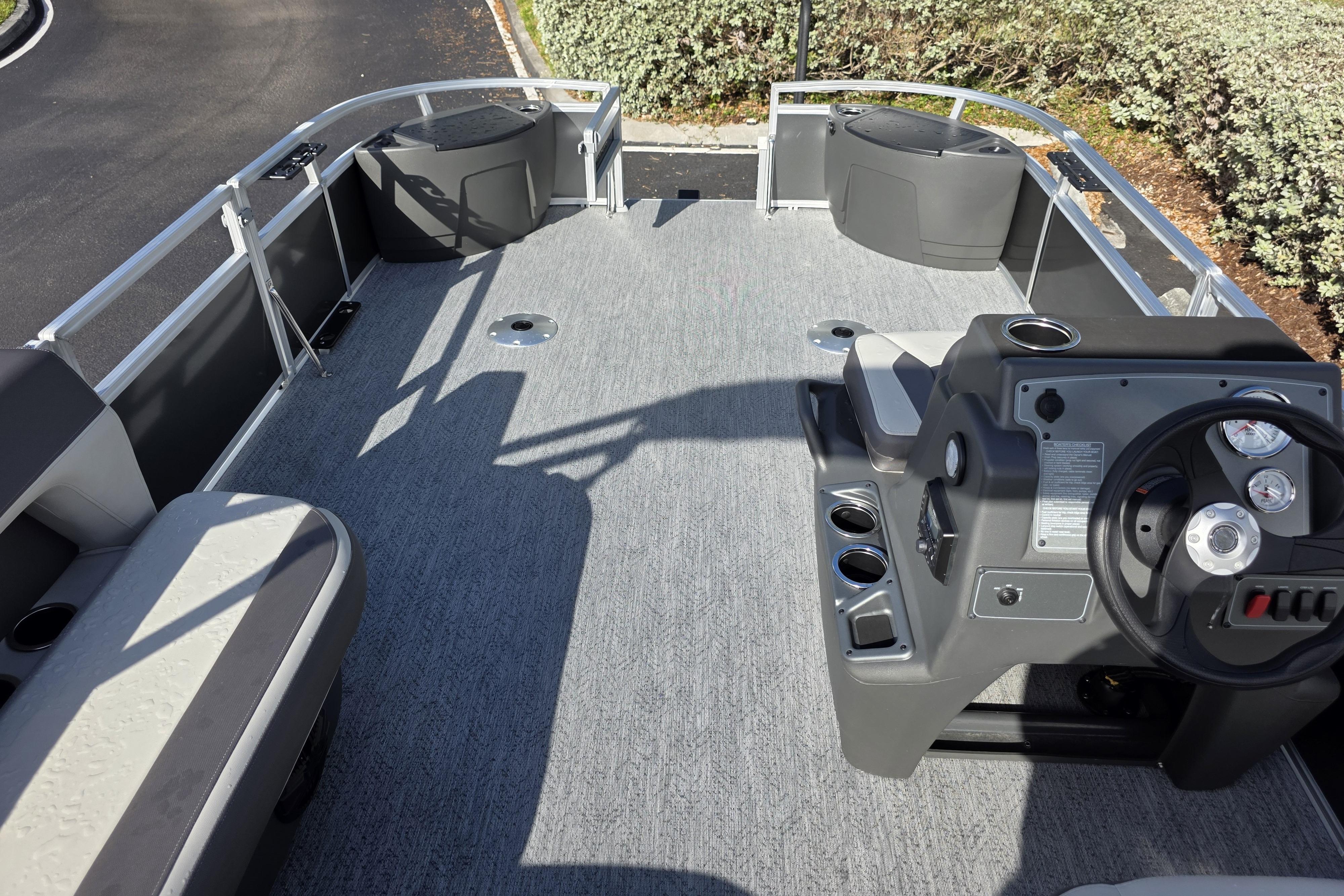 2026 Sun Tracker Bass Buggy 16 XL Select pontoon boat interior with steering console.