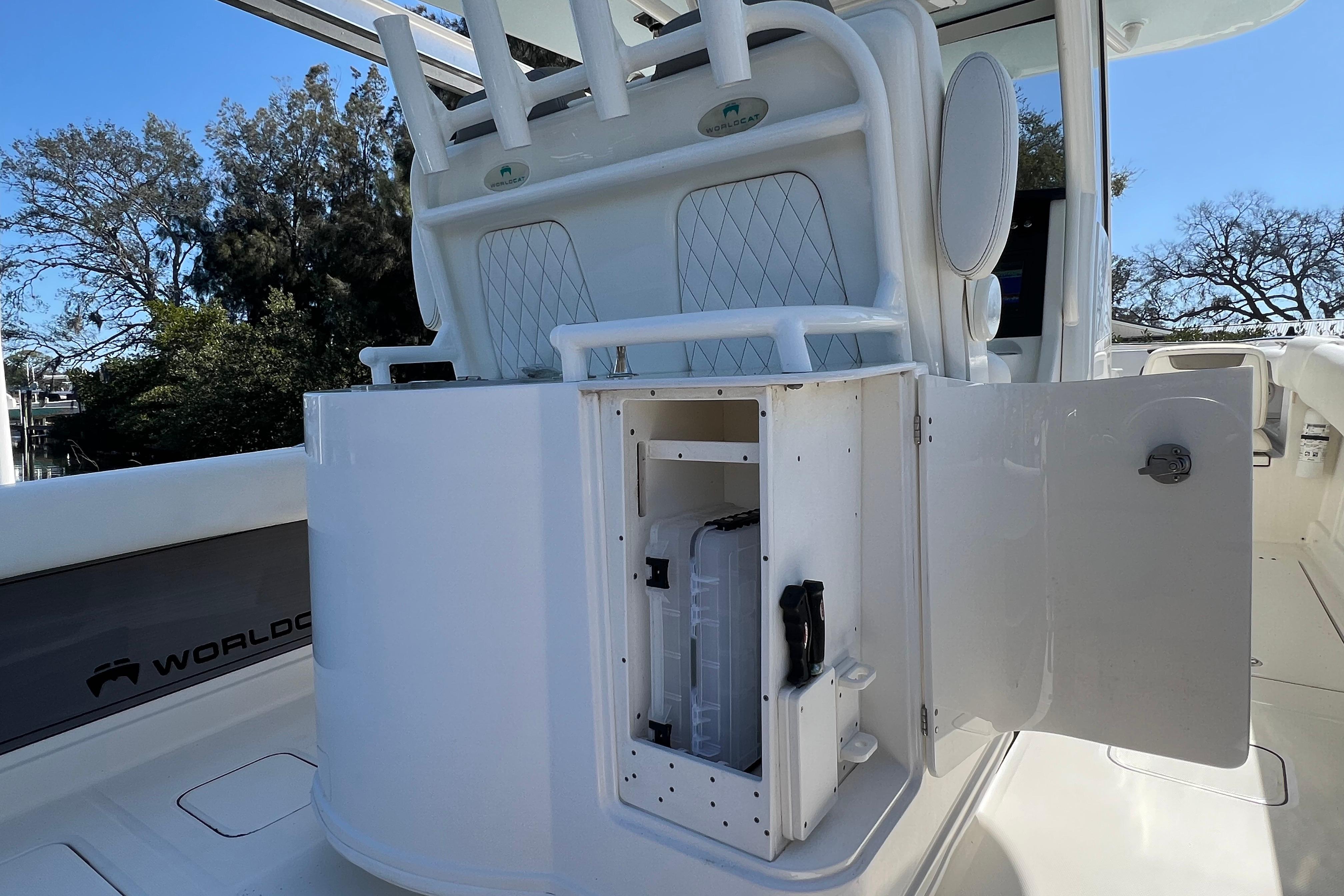 2022 World Cat 280 CC-X boat interior with open storage compartment and rod holders.