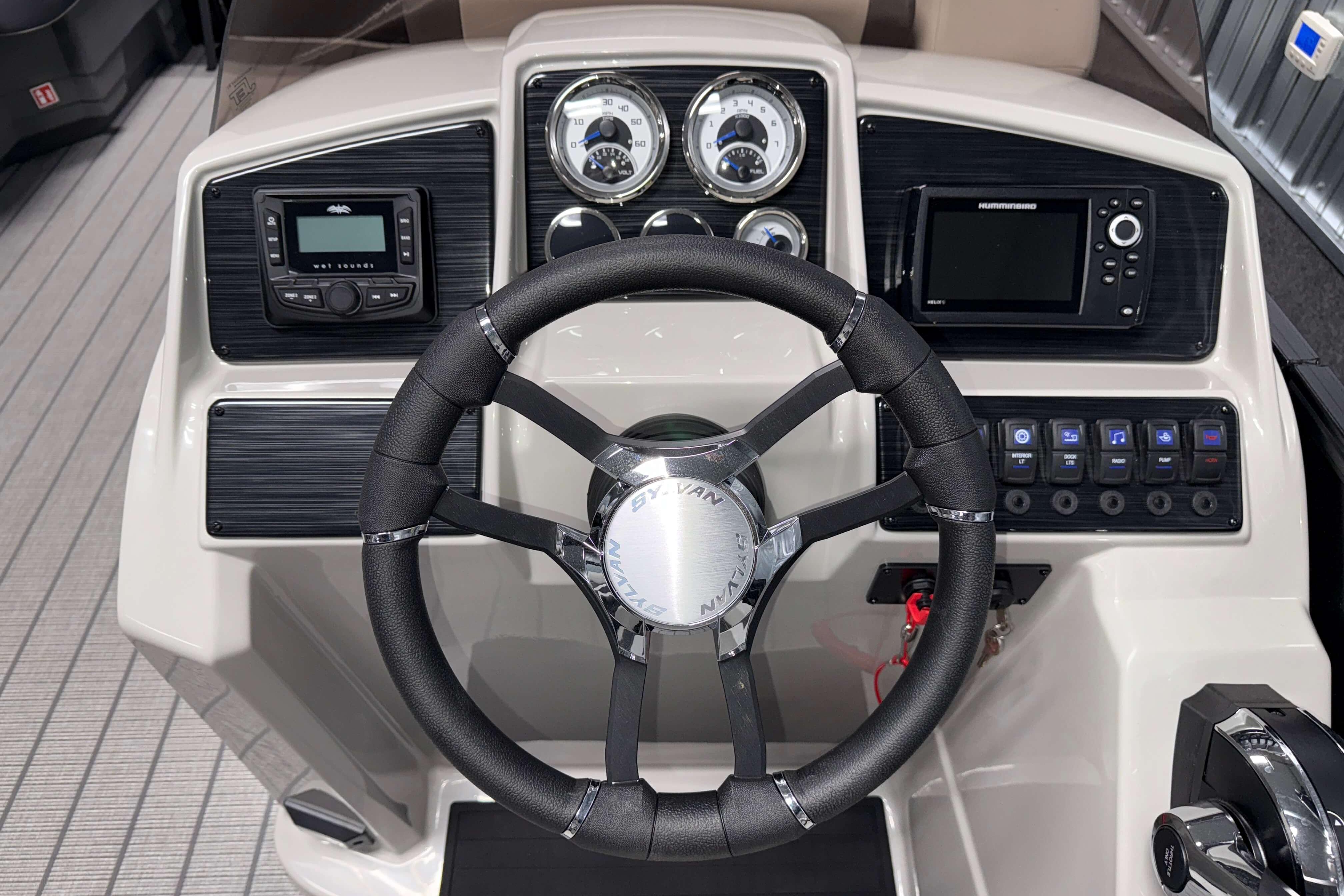 2026 Sylvan Mirage X1 boat dashboard with steering wheel and control panel.