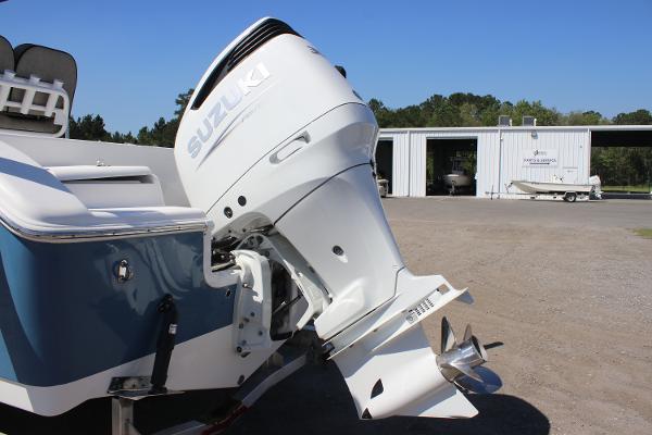2023 Sea Pro 239 Center Console with Suzuki outboard motor in a boatyard.