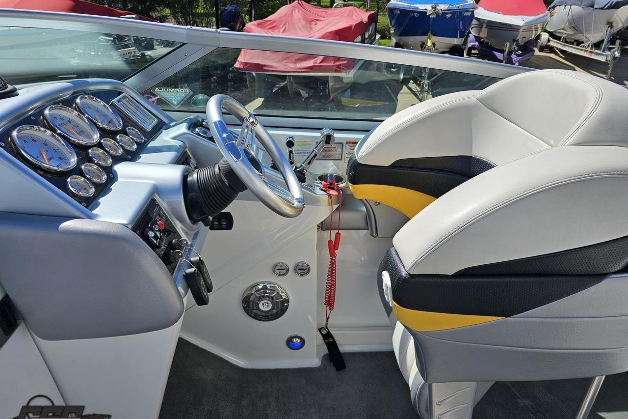 2014 Formula 292 FASTech boat cockpit with steering wheel and gauges.