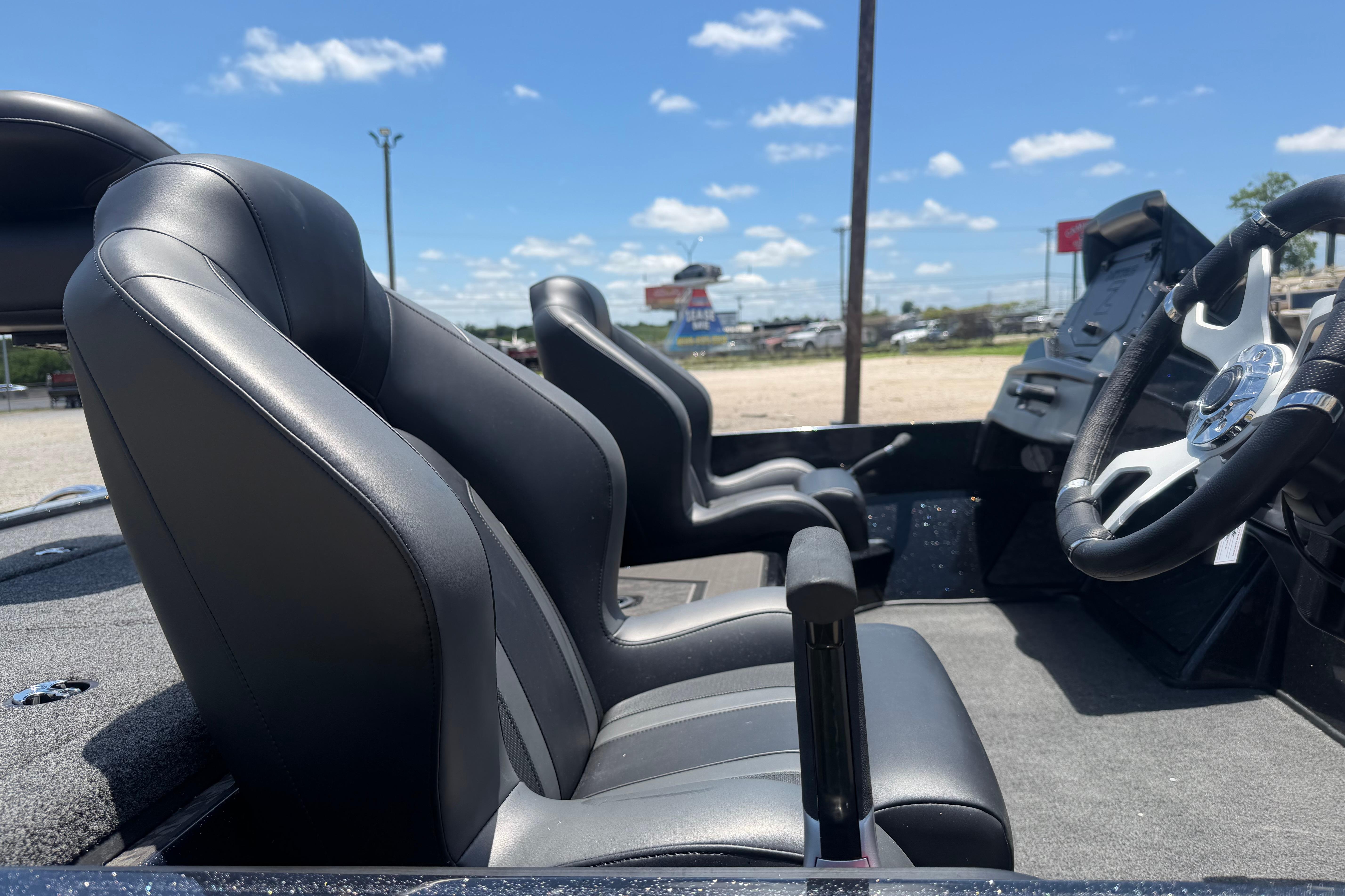 2026 Nitro Z20 XL Pro boat interior with sleek black seats and modern steering wheel.