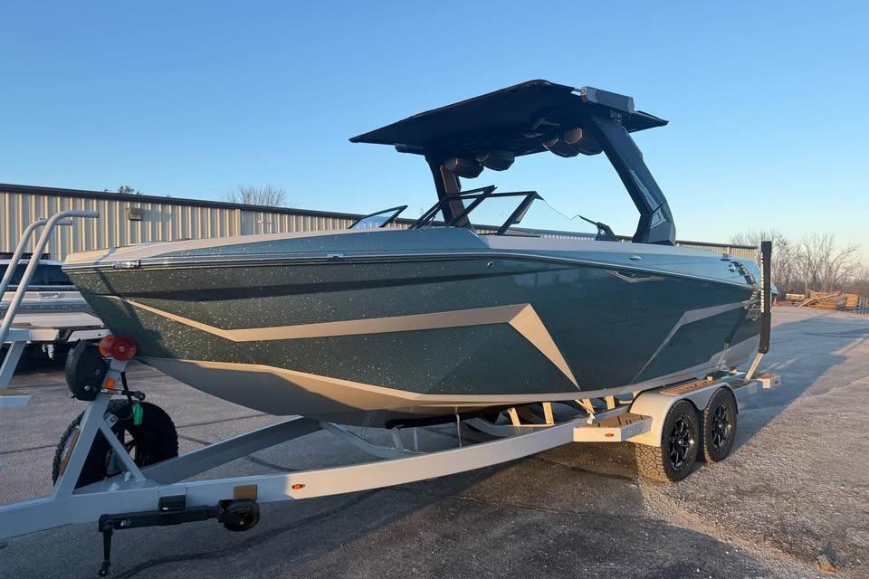 2026 Tigé Z3 boat on trailer, sleek design, parked outdoors.