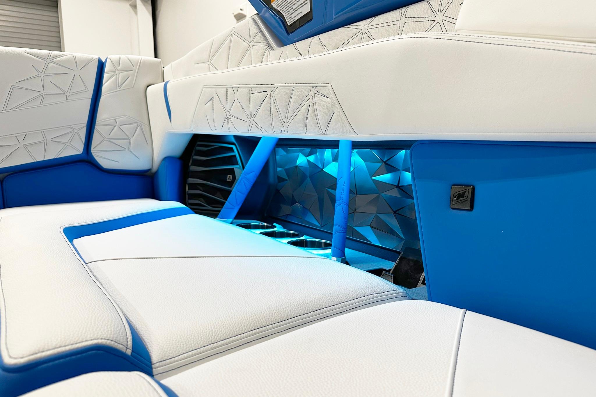 2025 Nautique Super Air Nautique G23 Paragon interior with blue LED lighting and white seating.
