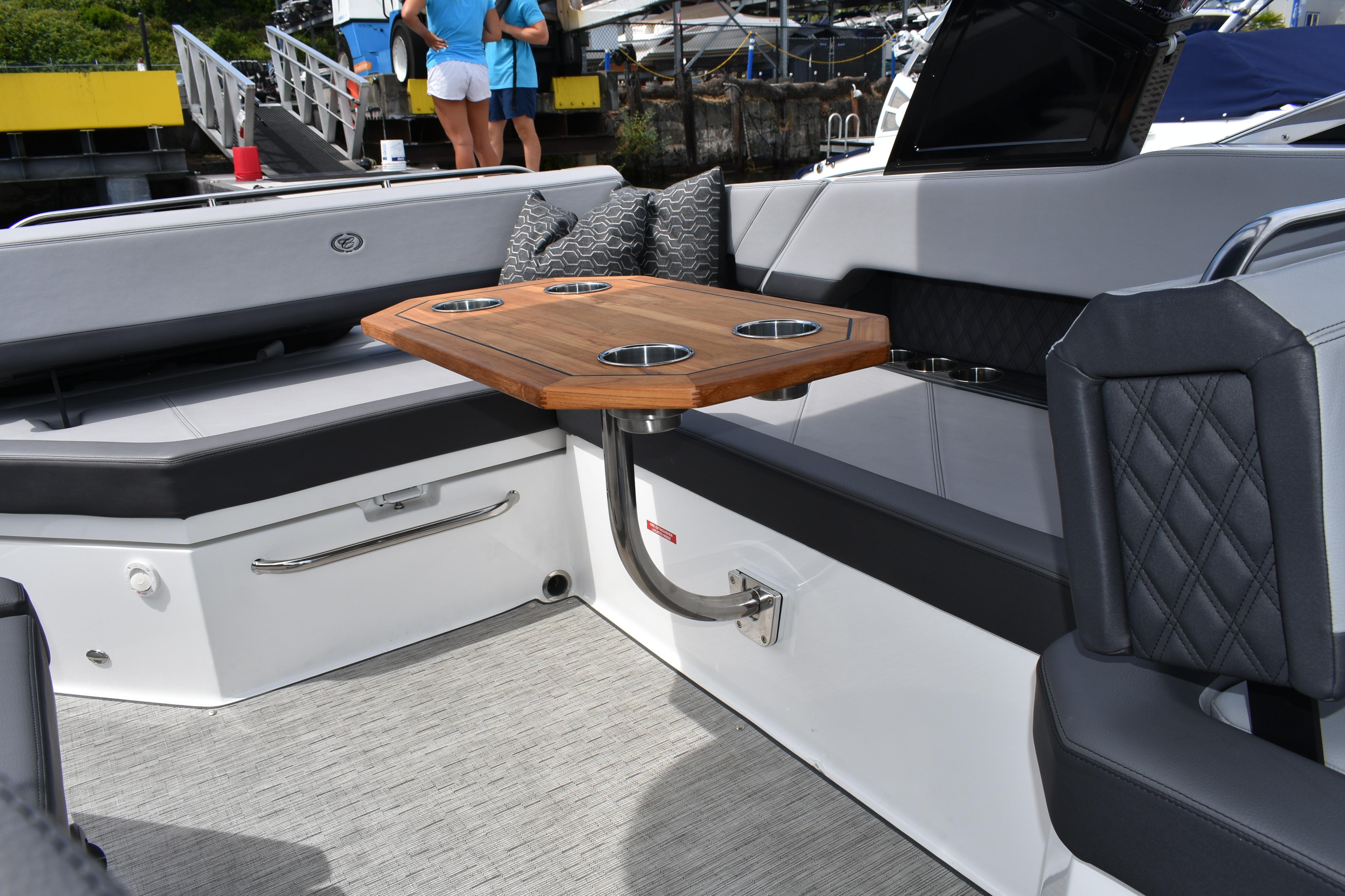 Luxurious interior of 2023 Cobalt R8 boat with elegant seating and wooden table.