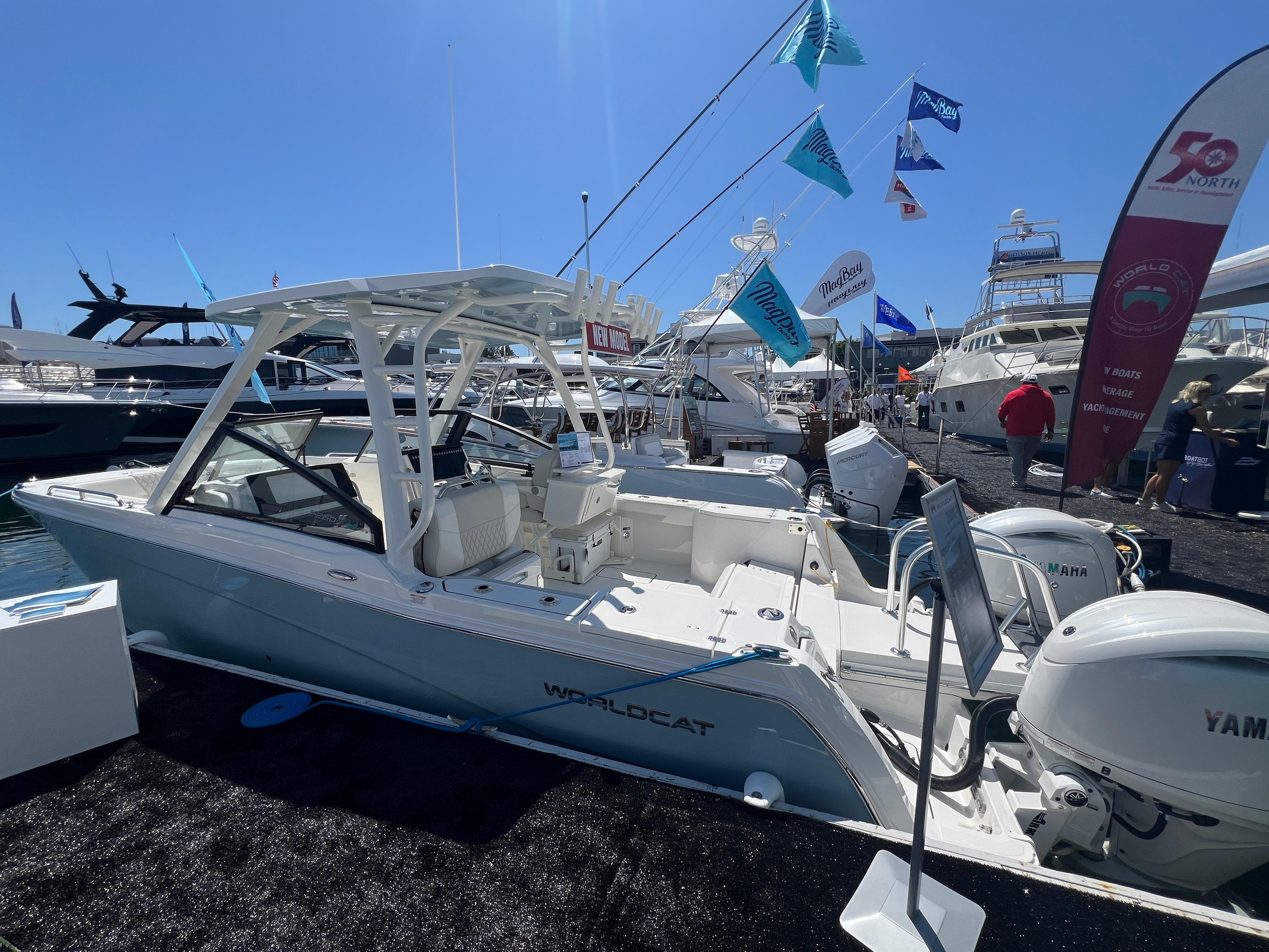 2024 World Cat 260 DC-X boat displayed at a marina event under clear blue skies.