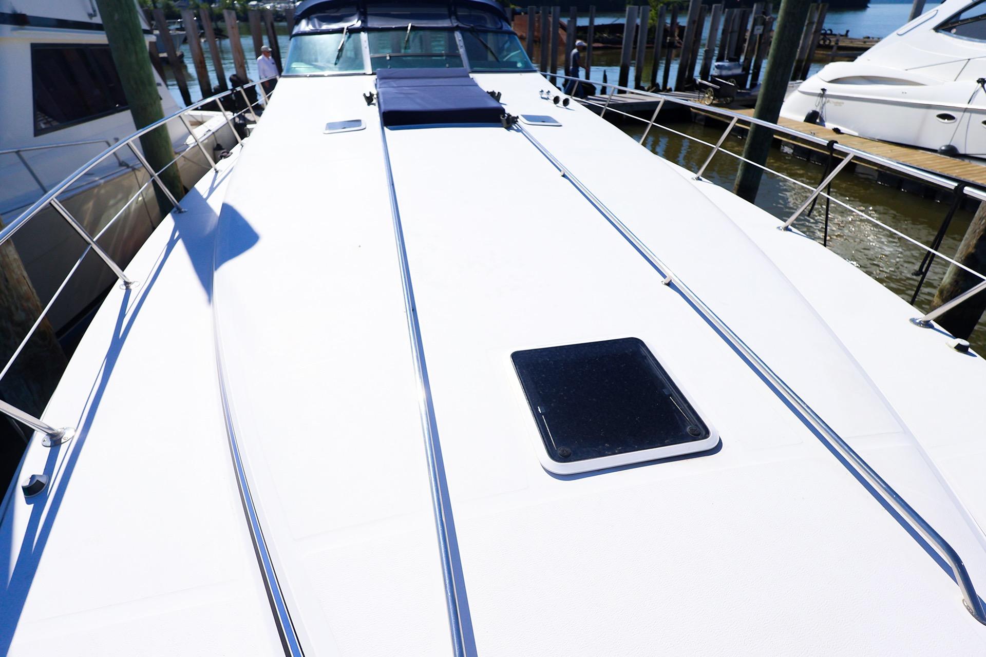 1998 Sea Ray 500 Sundancer yacht deck, docked at marina, showcasing sleek design and spacious layout.
