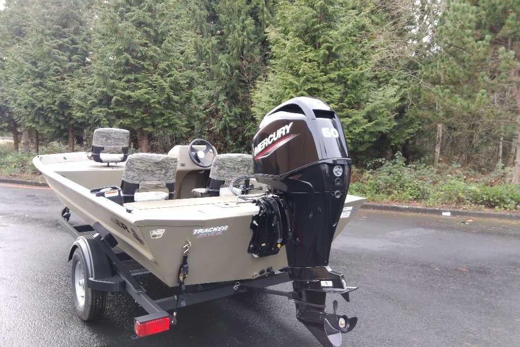 2026 Tracker Grizzly 1754 SC boat with Mercury 60 engine, parked outdoors.