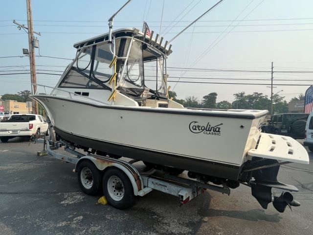 2002 Carolina Classic 25 boat on trailer outdoors.