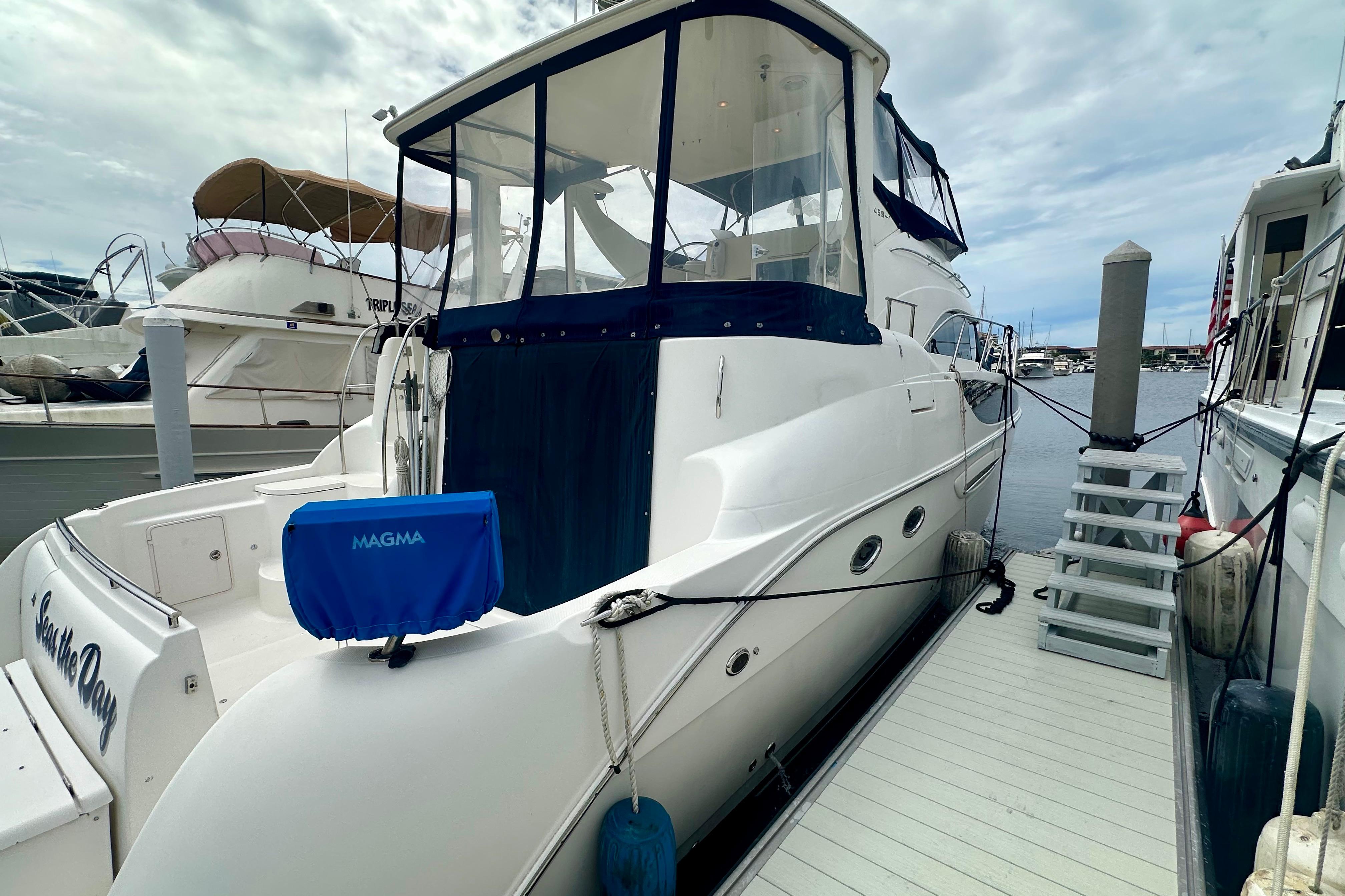 2005 Meridian 459 Motoryacht docked at marina, featuring sleek design and spacious deck.