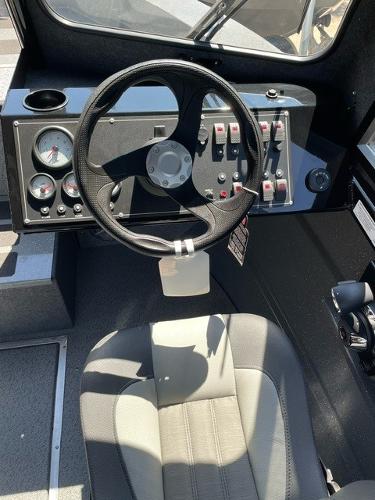 2024 Spartan 220 Maximus boat cockpit with steering wheel and control panel.