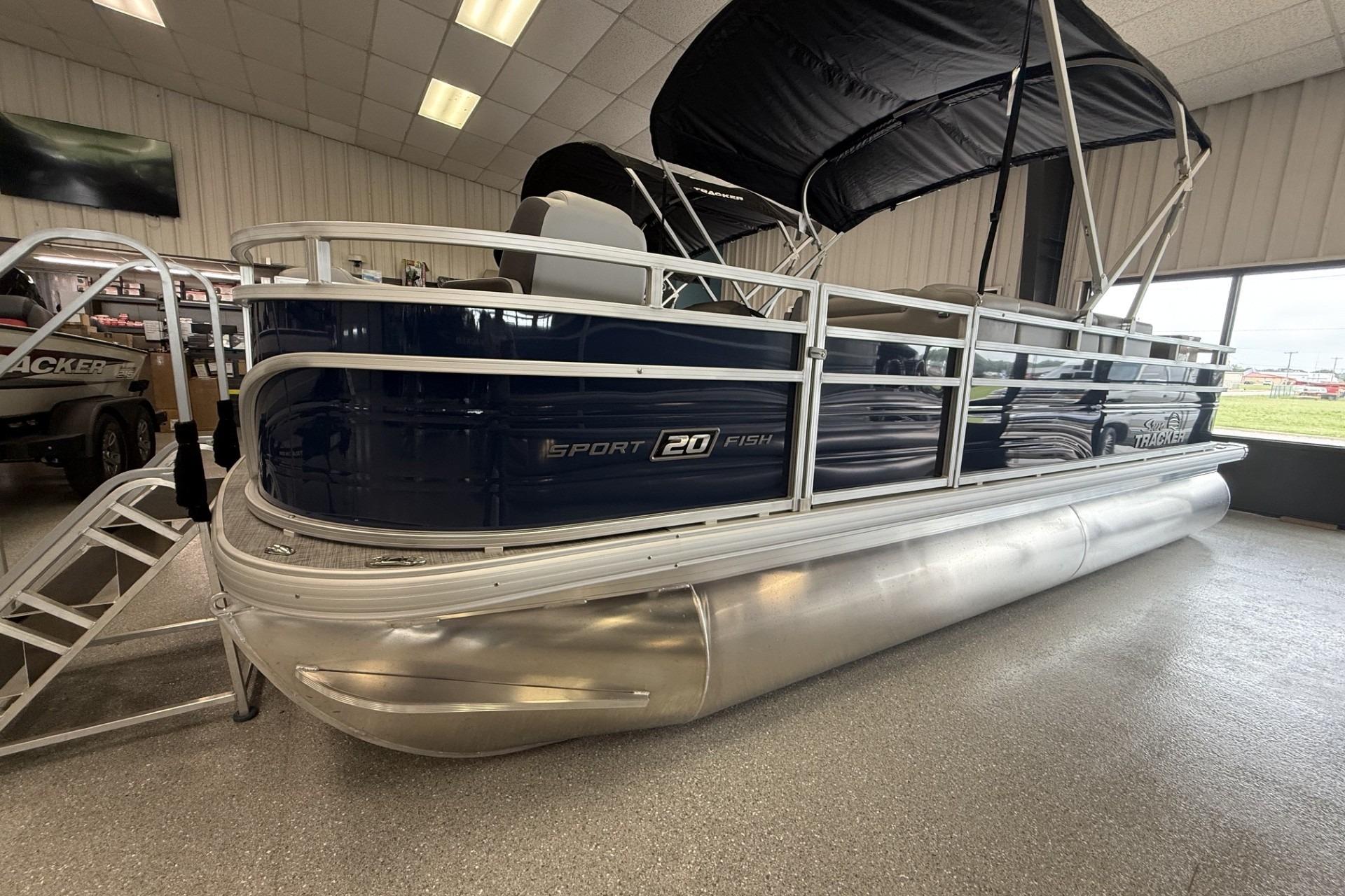 2026 Sun Tracker SportFish 20 DLX pontoon boat displayed indoors with sleek design.