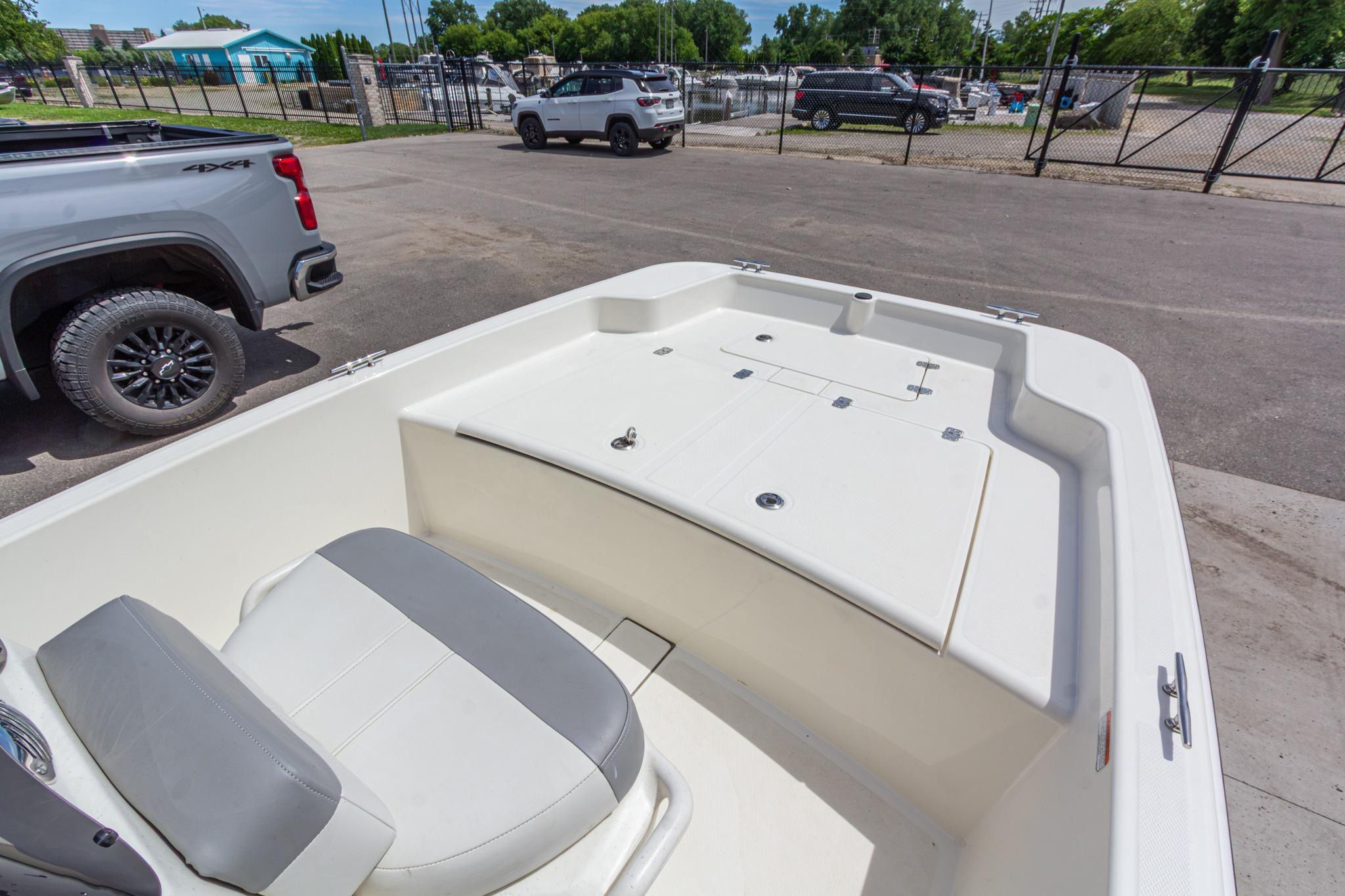 2020 Mako Pro Skiff 15 CC boat interior with seating and storage, parked outdoors.