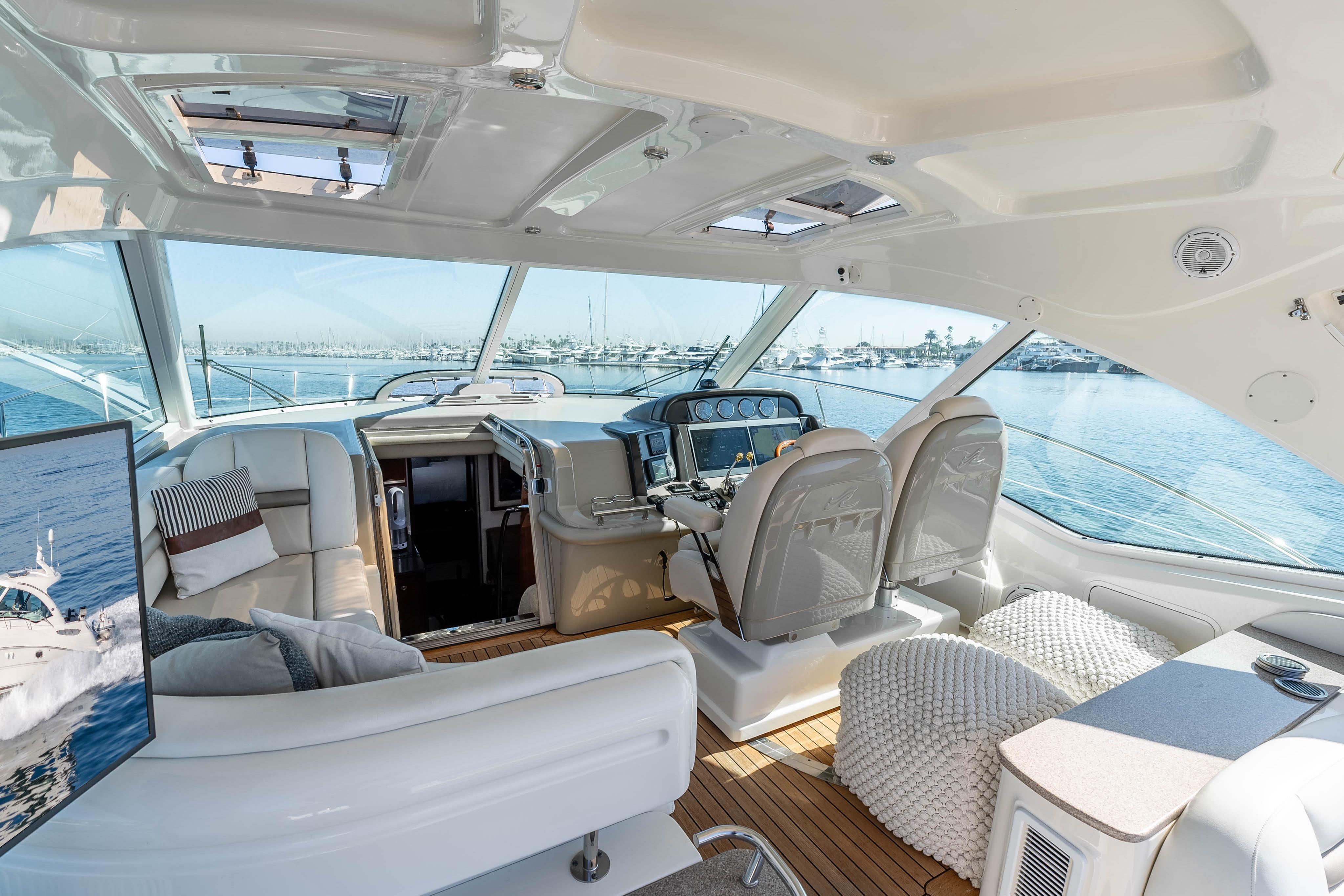 Luxurious interior of 2007 Sea Ray 48 Sundancer yacht with panoramic windows and plush seating.