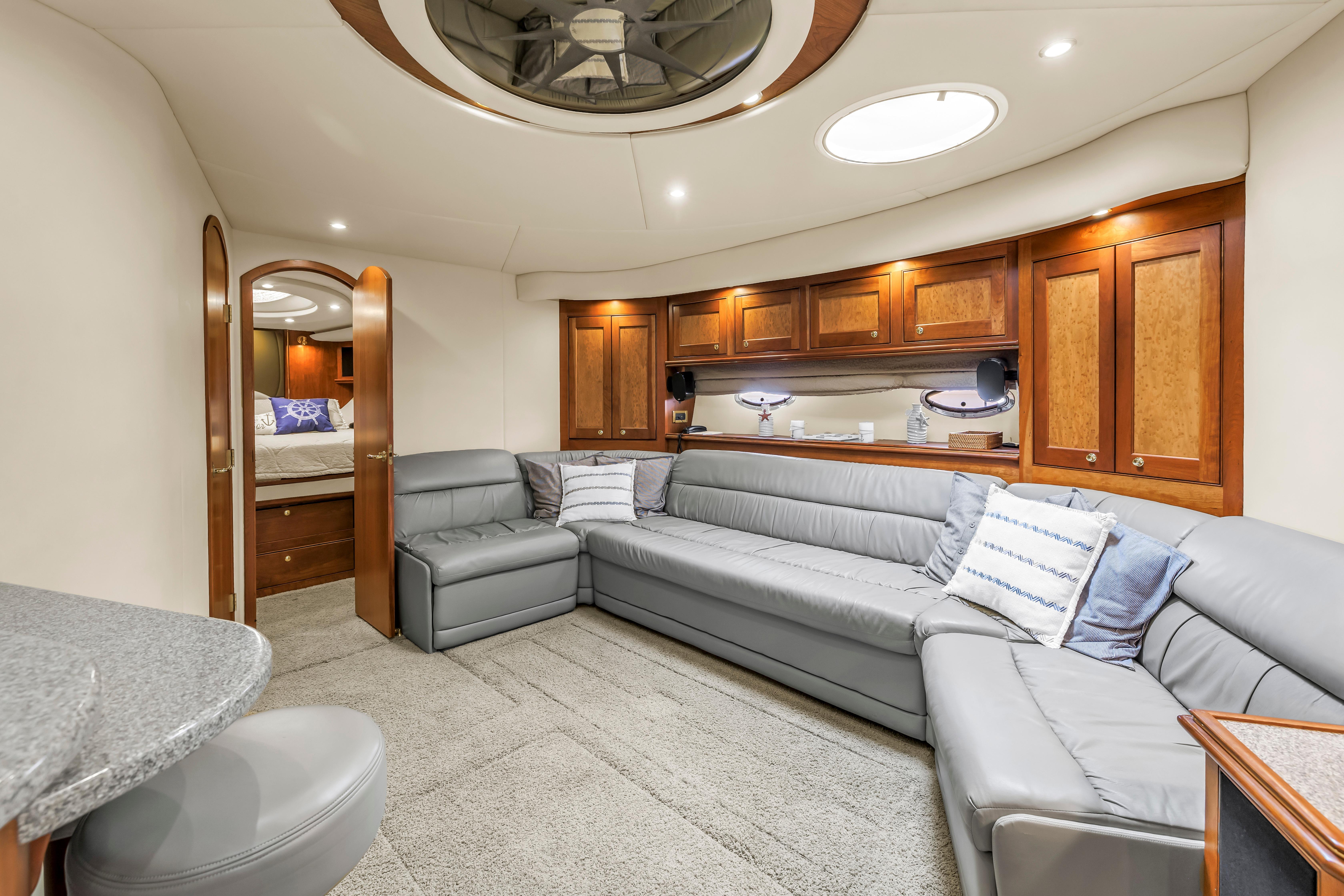 Luxurious 2002 Cruisers 5370 yacht interior with elegant seating and wooden cabinetry.