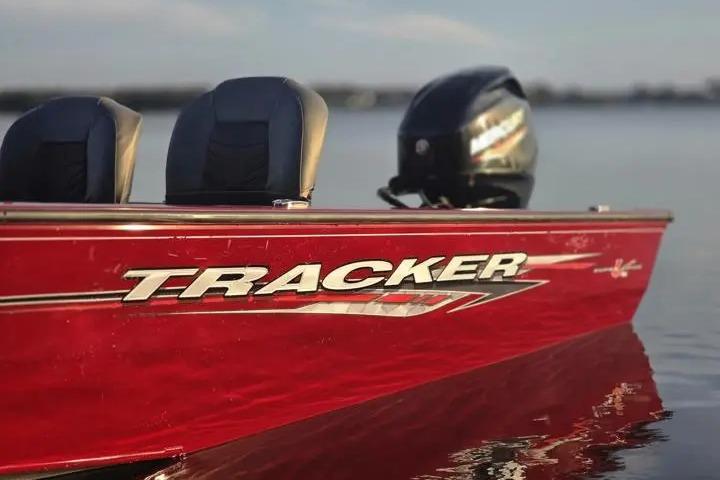 2021 Tracker Super Guide V-16 SC boat on calm water, featuring red exterior.