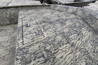2026 Tracker Grizzly 1860 Utility boat with camouflage pattern deck.